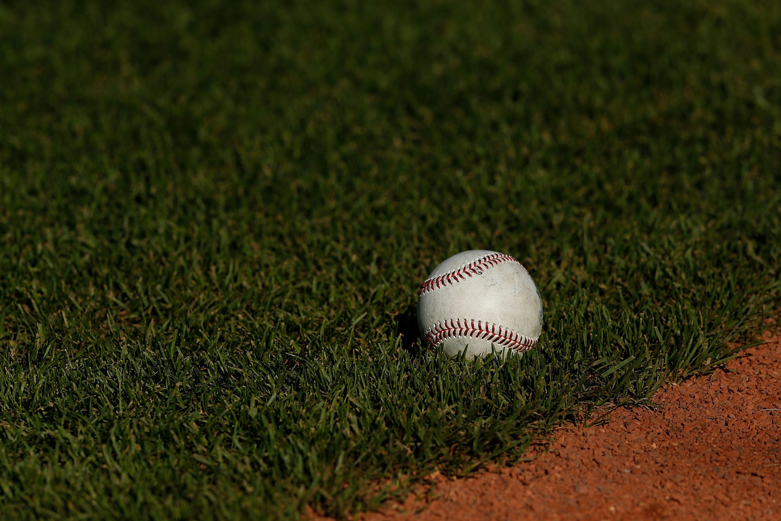 A baseball lays on the field before the game between the Colorado Rockies and the San Francisco Gia...