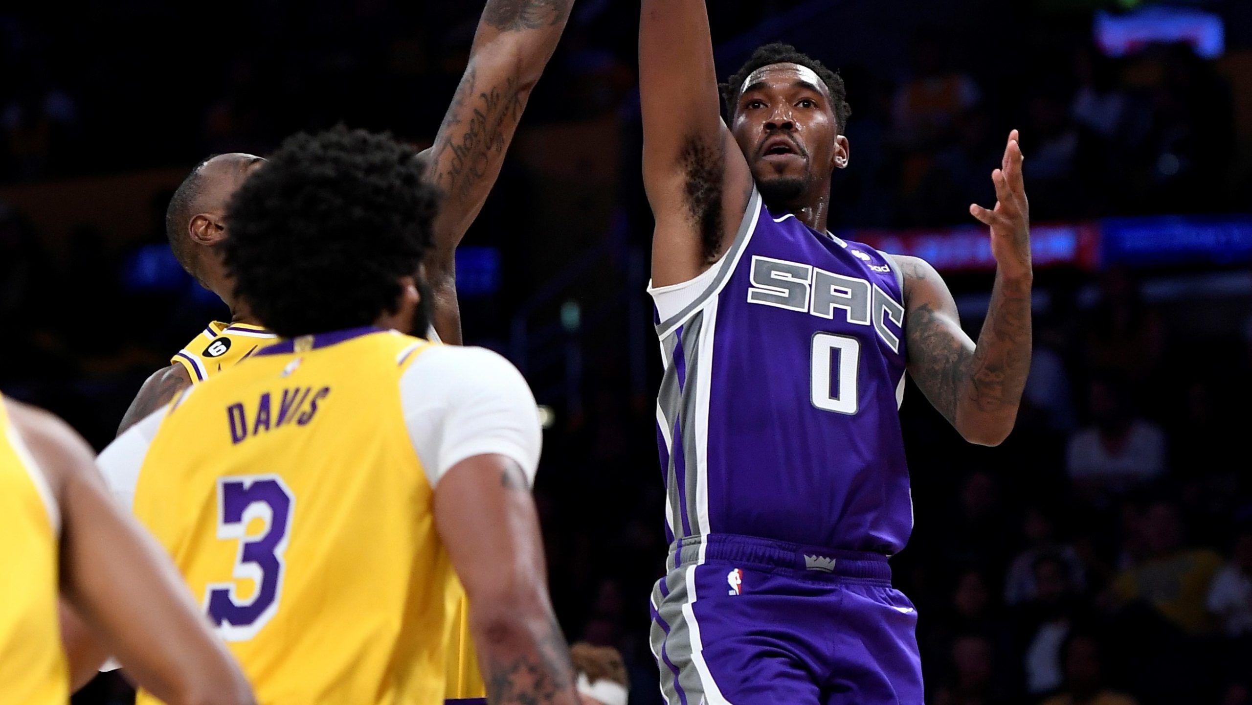 Malik Monk #0 of the Sacramento Kings shoots over LeBron James #6 of the Los Angeles Lakers during ...