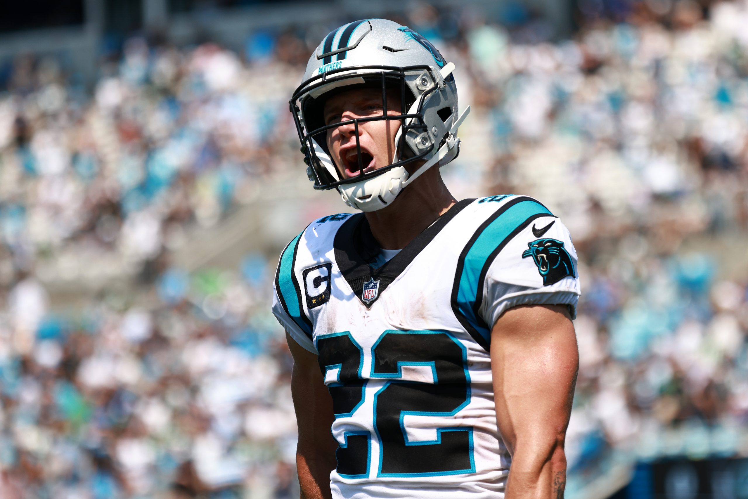 Christian McCaffrey #22 of the Carolina Panthers reacts after a teammates' touchdown reception agai...
