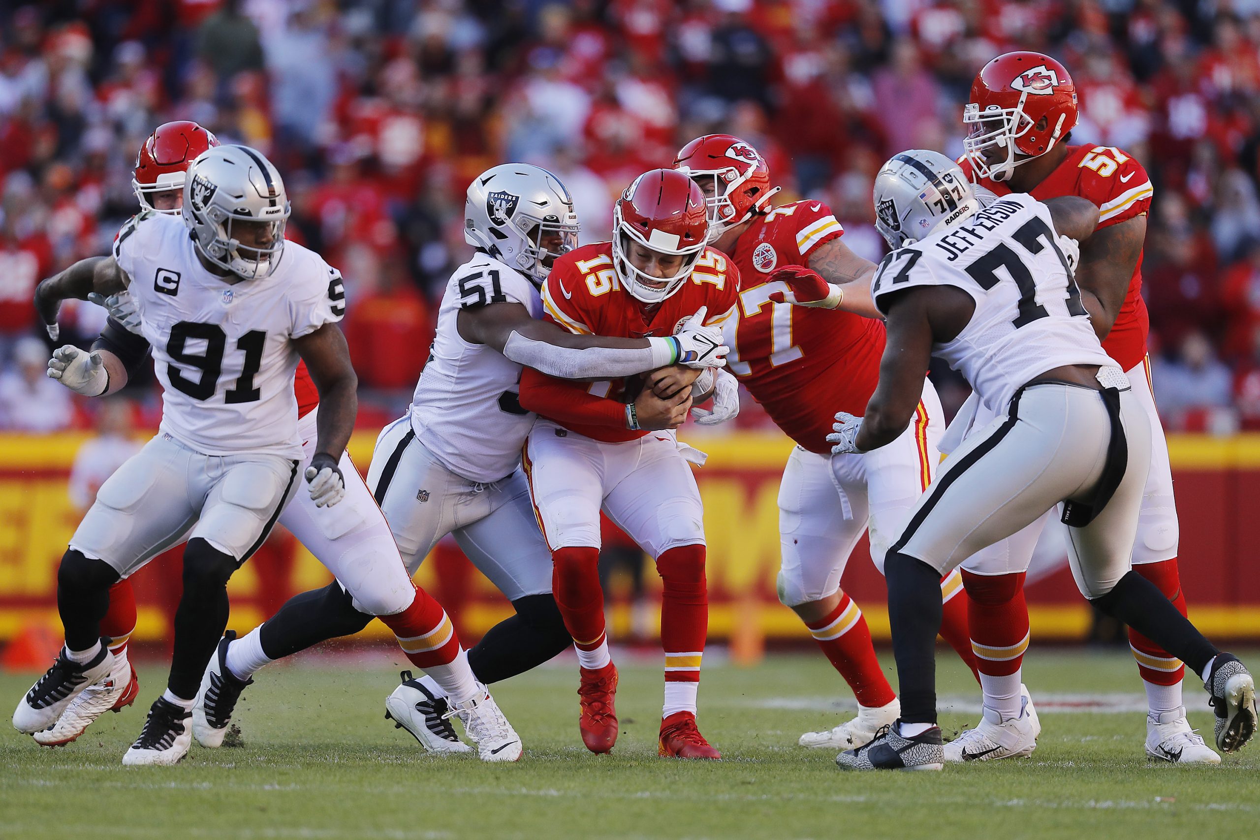 Patrick Mahomes #15 of the Kansas City Chiefs is sacked by Malcolm Koonce #51 of the Las Vegas Raid...