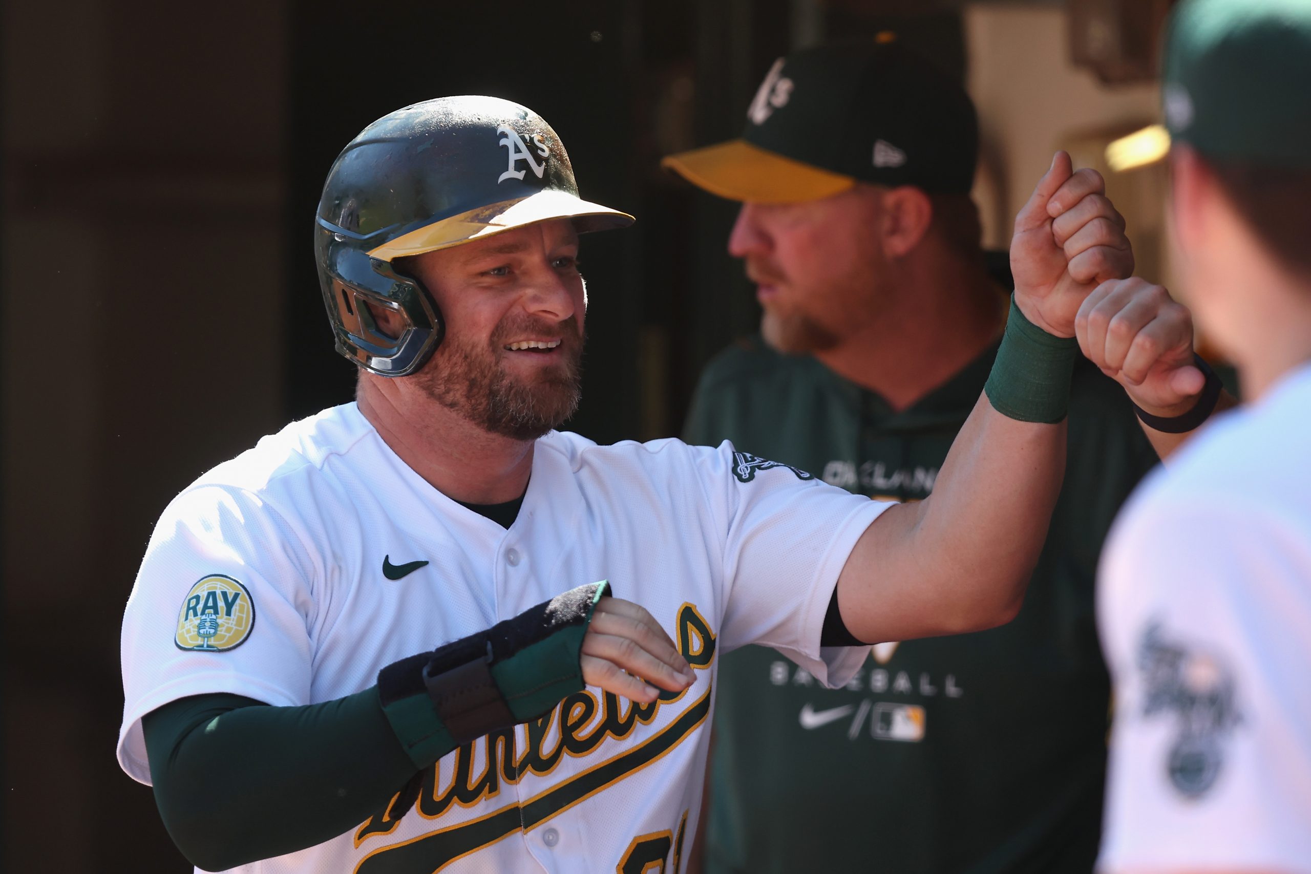 Stephen Vogt #21 of the Oakland Athletics celebrates in the dugout after scoring on a double by She...