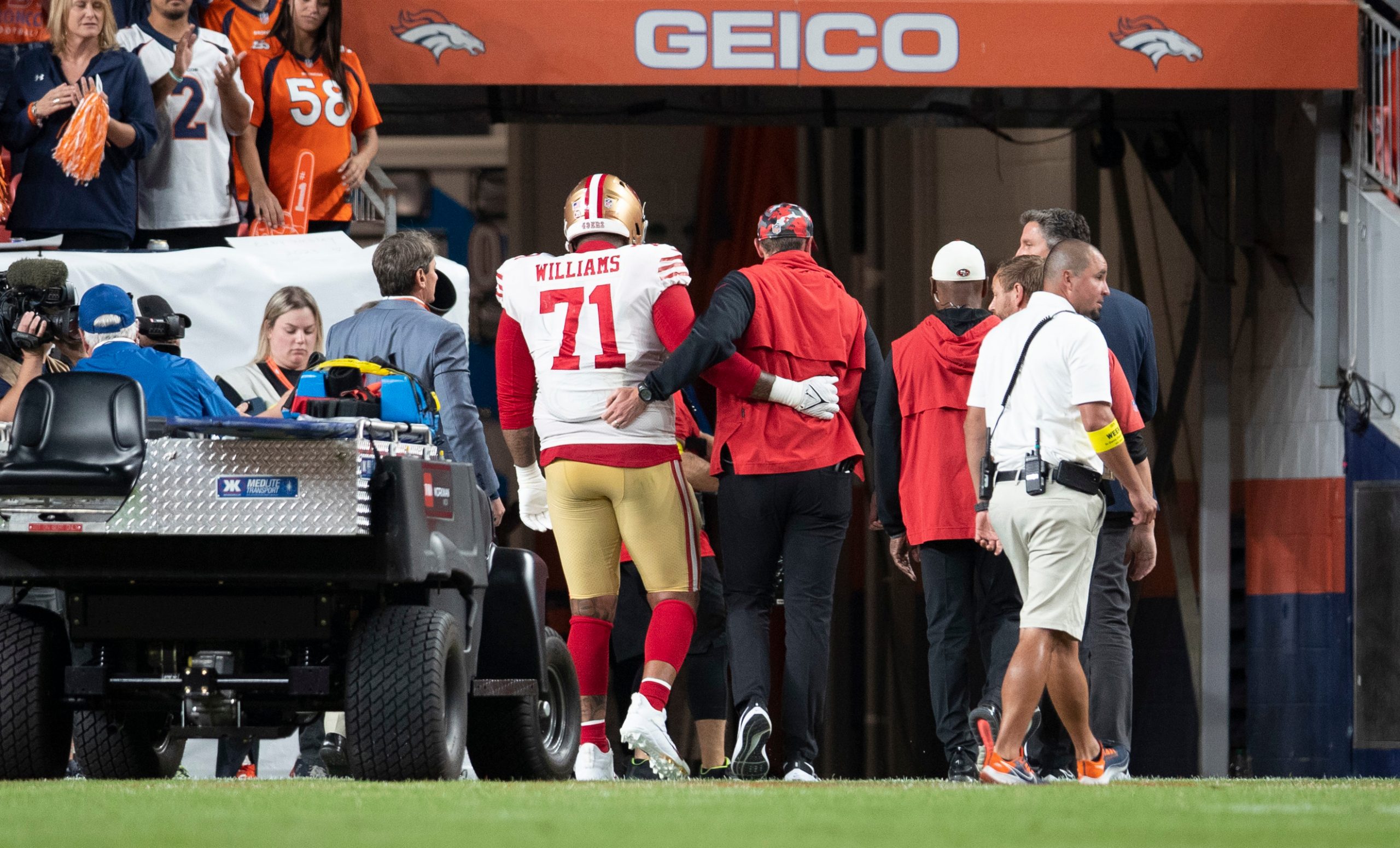 Trent Williams #71 gets helped off the field after suffering an ankle injury of the San Francisco 4...
