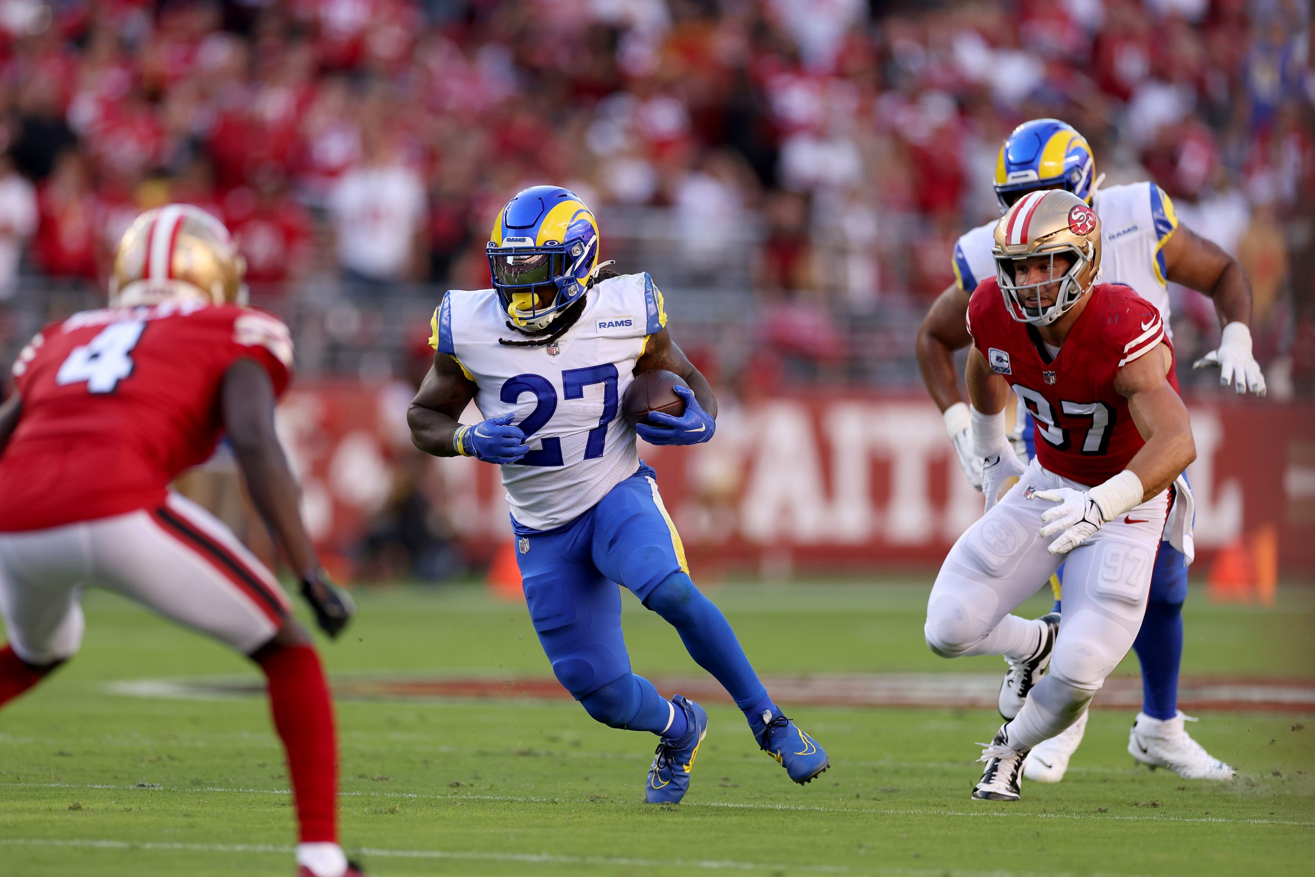 Darrell Henderson Jr. #27 of the Los Angeles Rams runs with the ball against the San Francisco 49er...