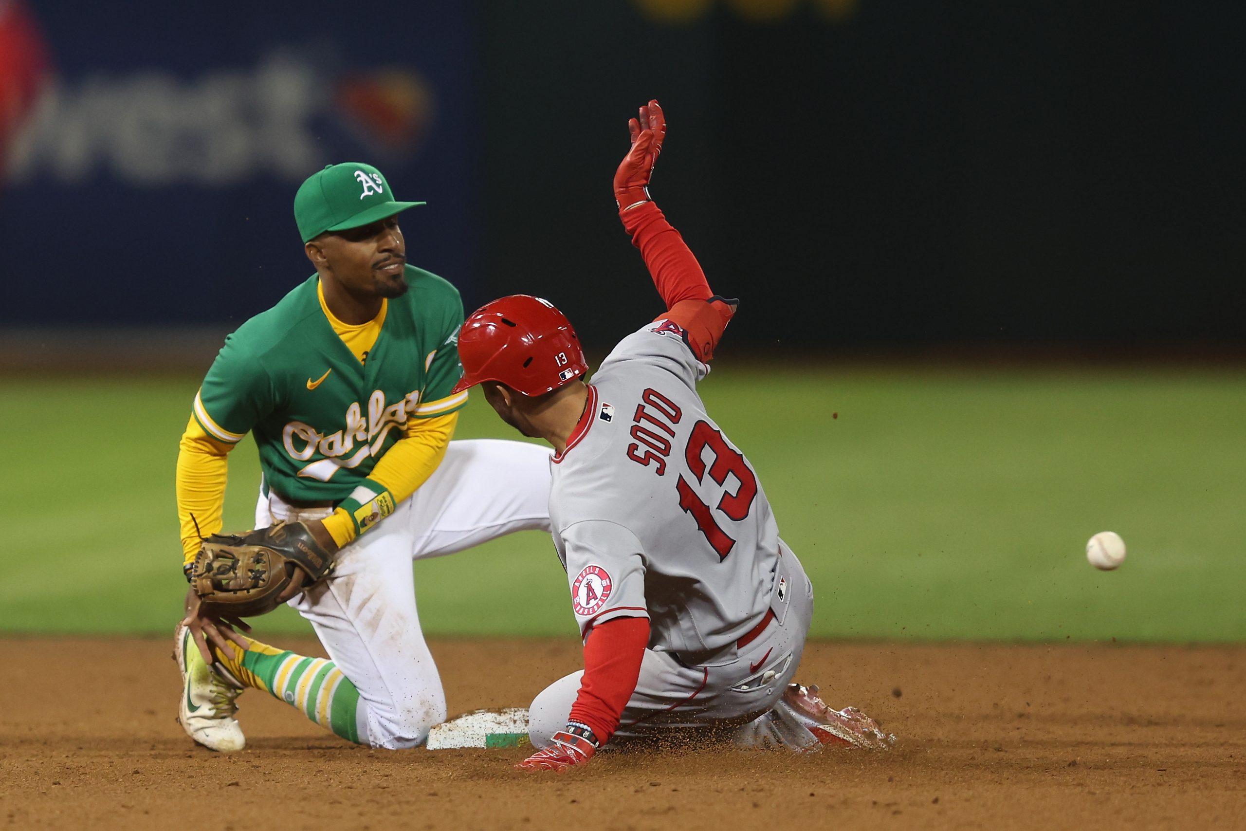 Livan Soto #13 of the Los Angeles Angels reaches second base as Tony Kemp #5 of the Oakland Athleti...