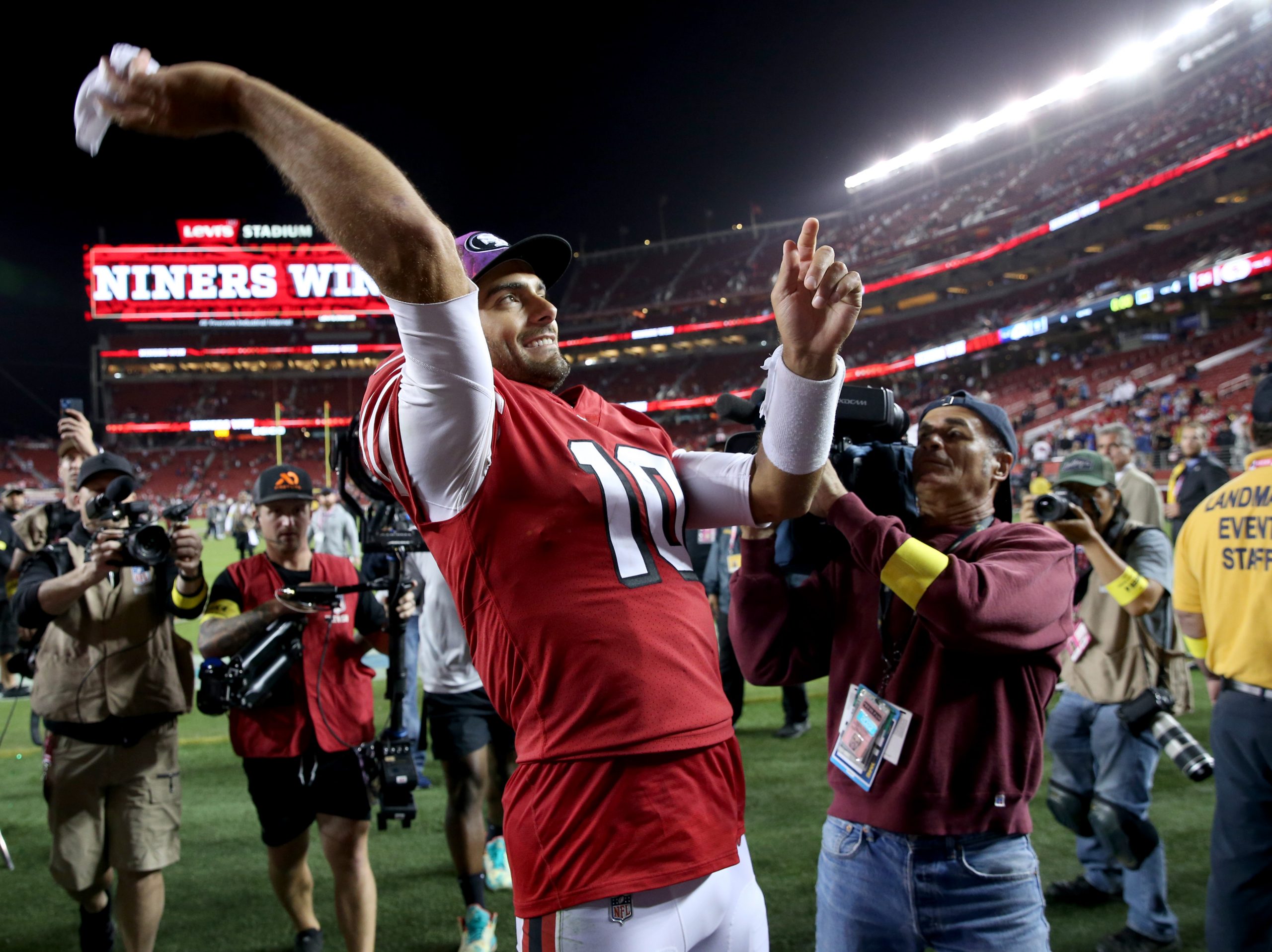 OCTOBER 03: San Francisco 49ers quarterback Jimmy Garoppolo #10 throws his wristband to fans as he ...