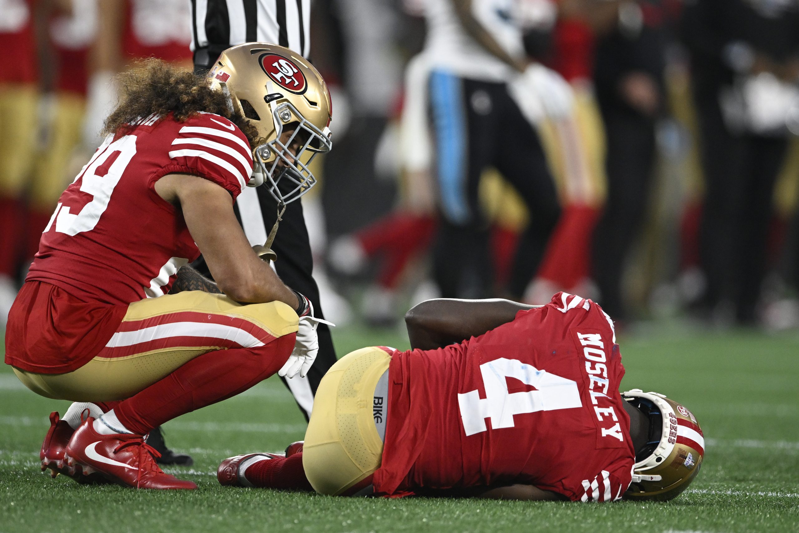 Emmanuel Moseley #4 of the San Francisco 49ers on the field with an injury during the second half i...