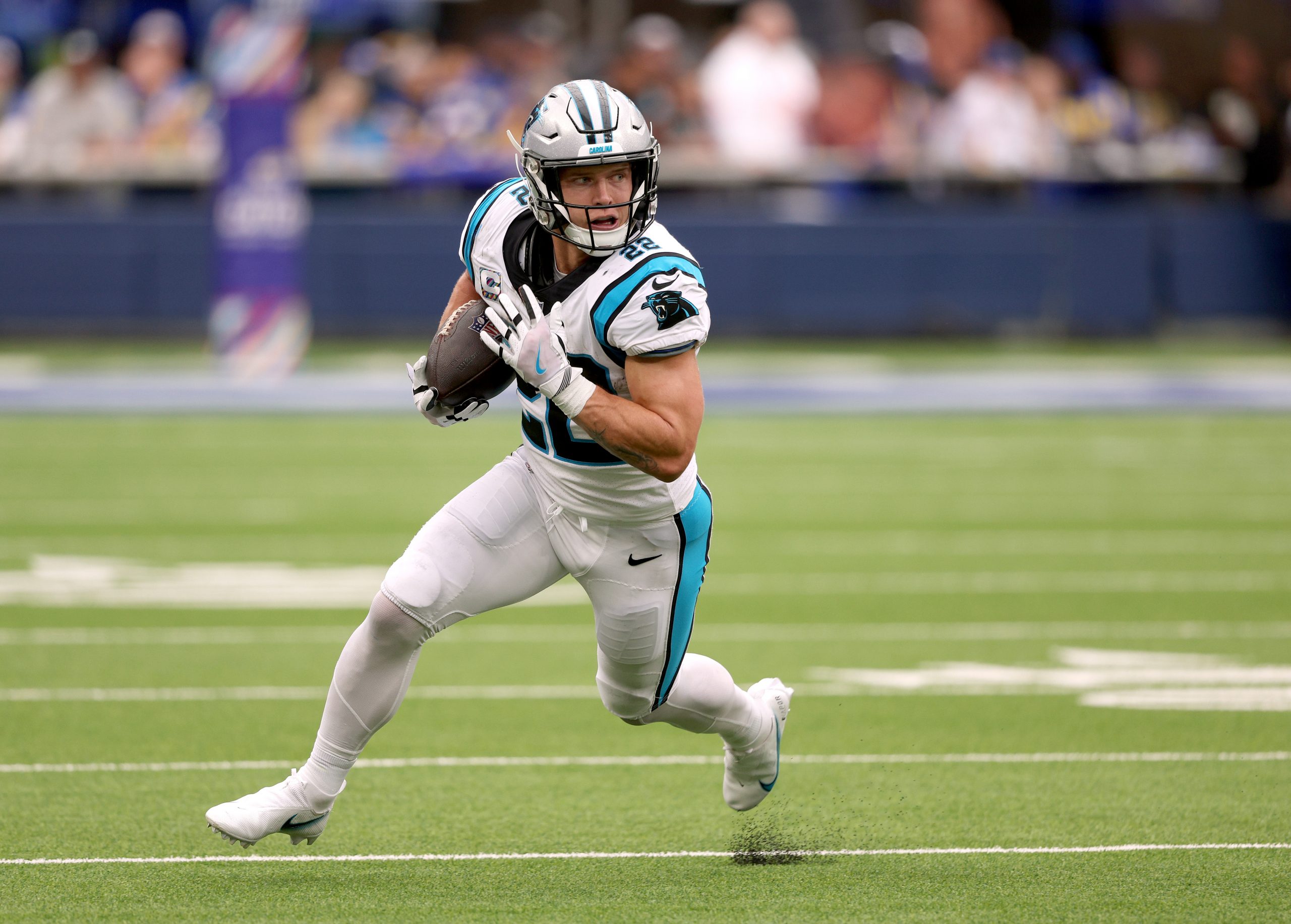 Christian McCaffrey #22 of the Carolina Panthers runs after his catch during a 24-10 loss to the Lo...