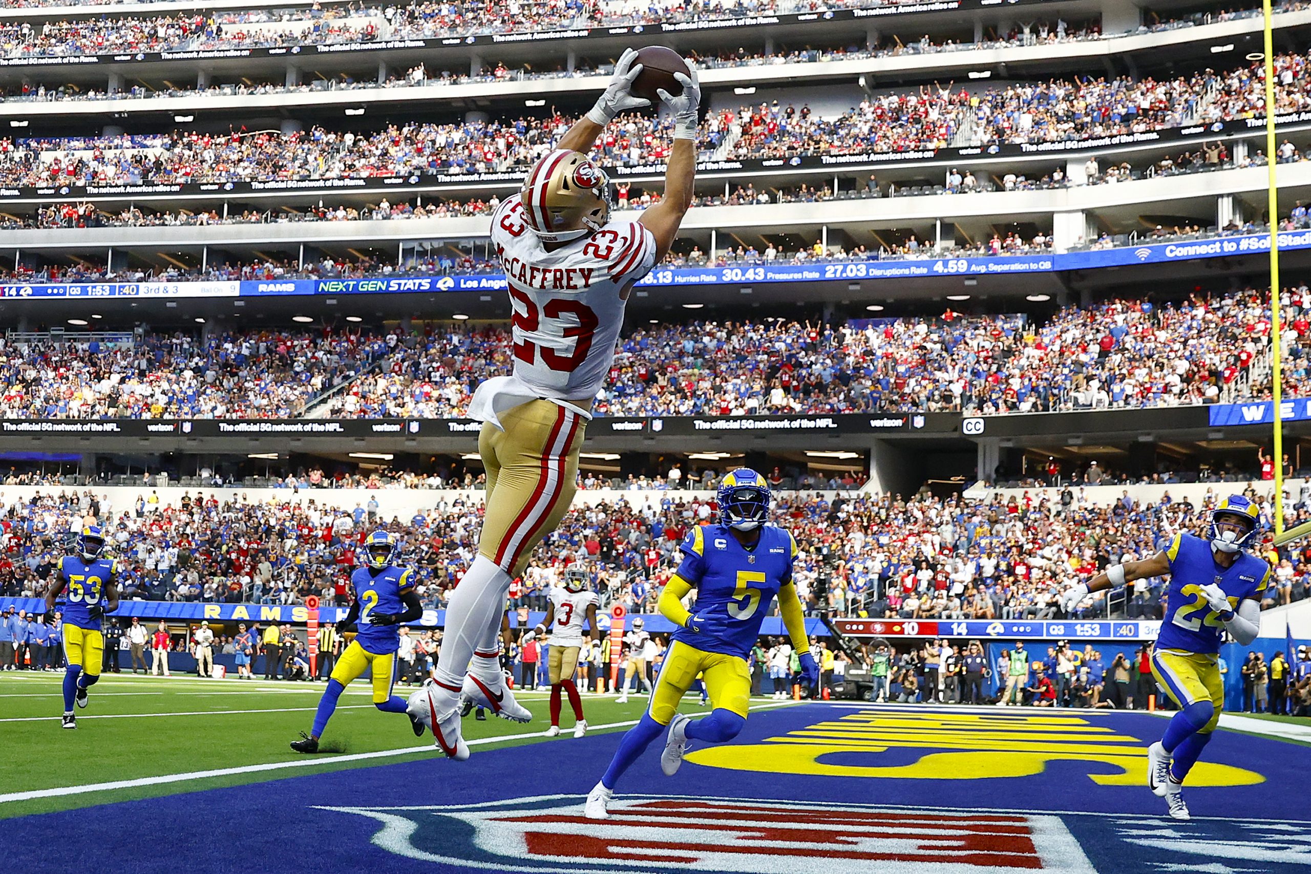 Christian McCaffrey #23 of the San Francisco 49ers catches the ball for a touchdown as Jalen Ramsey...