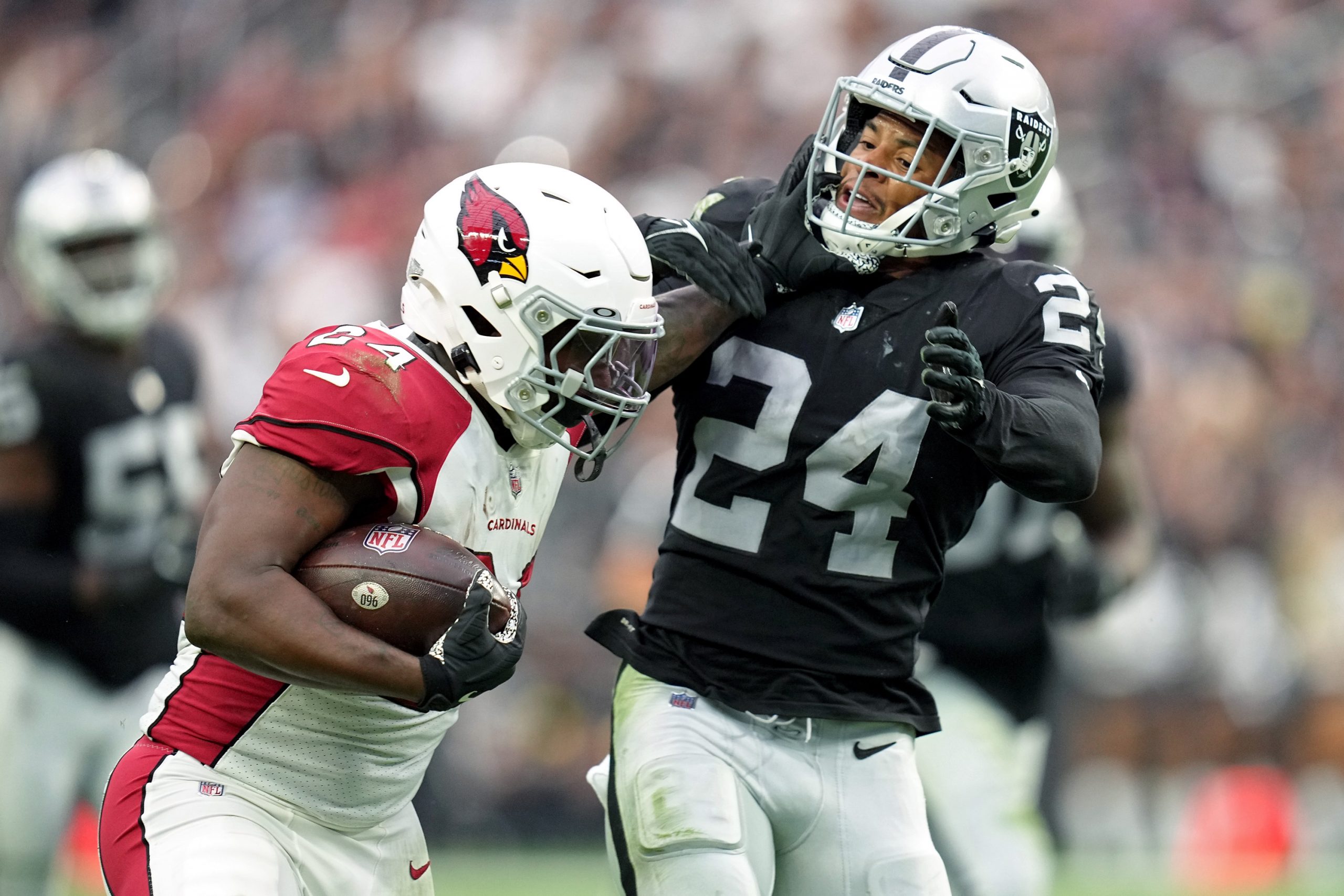 Darrel Williams #24 of the Arizona Cardinals carries the ball against Johnathan Abram #24 of the La...