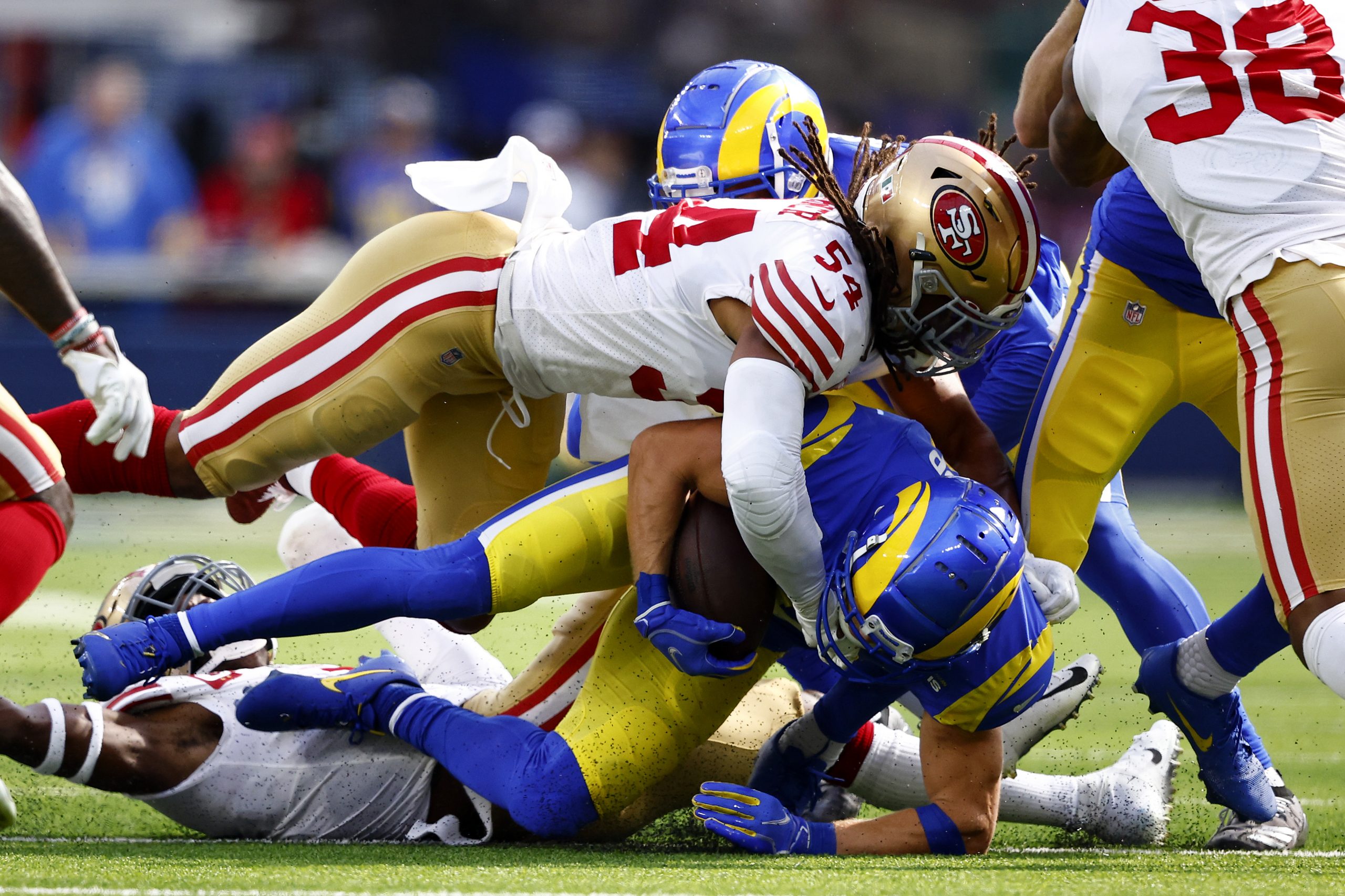 Cooper Kupp #10 of the Los Angeles Rams is tackled by Fred Warner #54 of the San Francisco 49ers du...