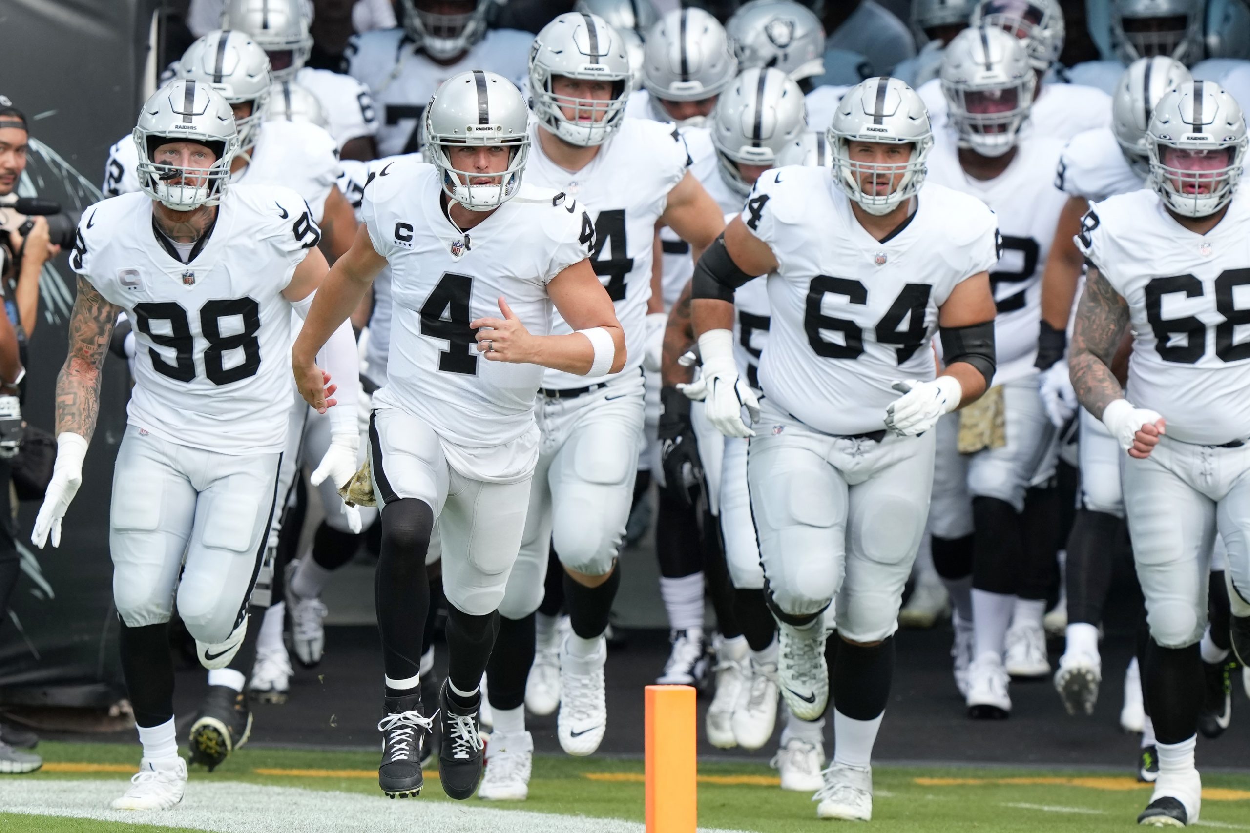 Derek Carr #4 of the Las Vegas Raiders leads the team out to the field prior to the game against th...