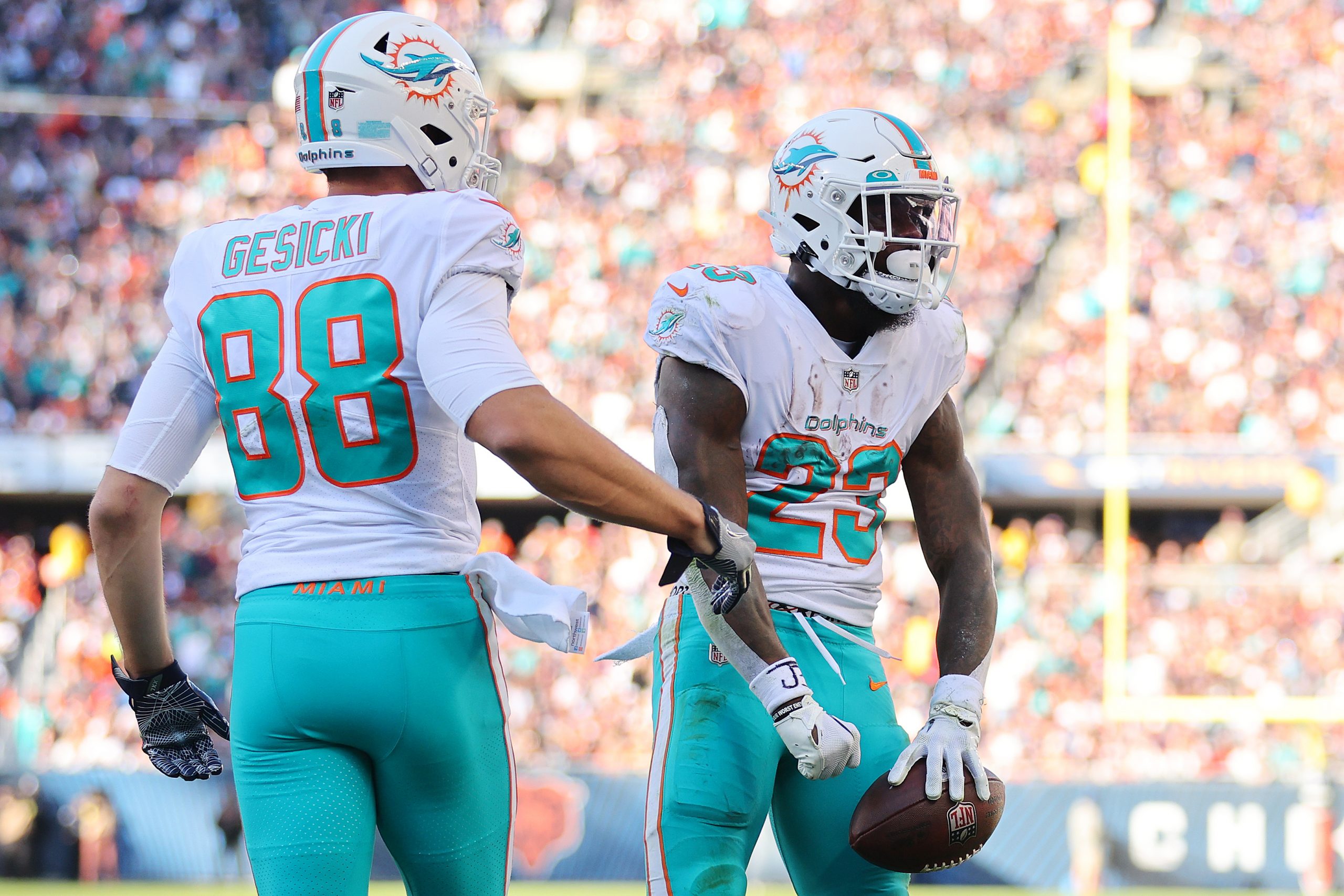Jeff Wilson Jr. #23 of the Miami Dolphins celebrates a touchdown against the Chicago Bears at Soldi...
