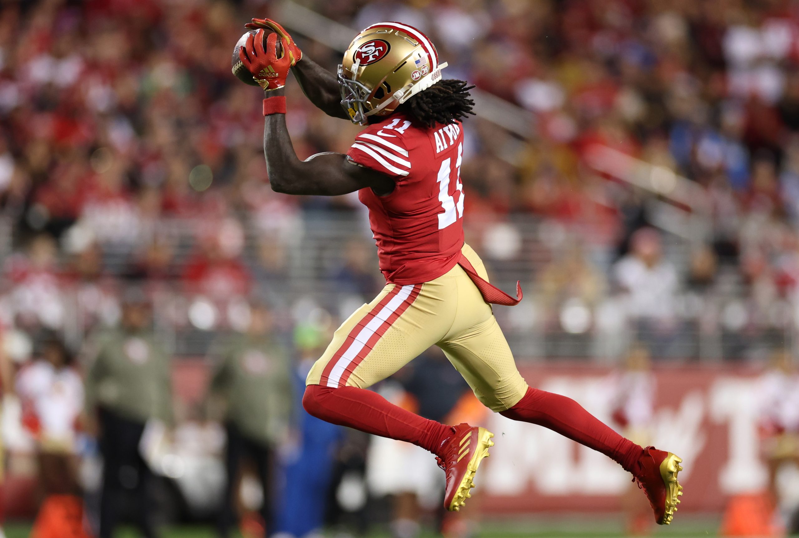 Brandon Aiyuk #11 of the San Francisco 49ers catches a pass during the first quarter against the Lo...