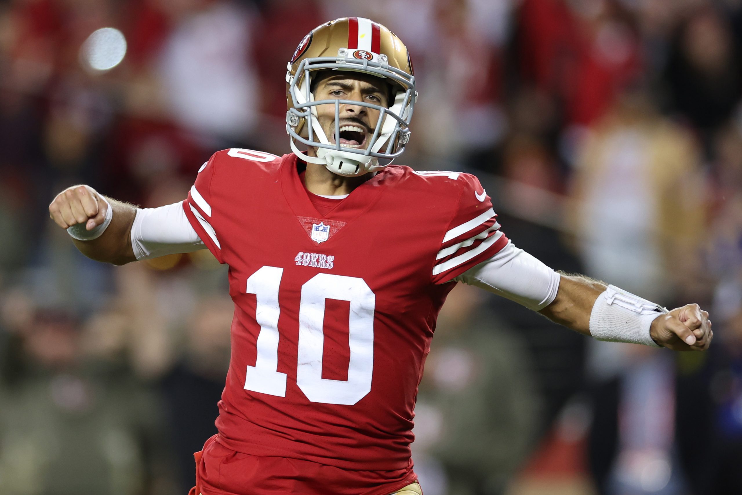 Jimmy Garoppolo #10 of the San Francisco 49ers celebrates after a touchdown by Christian McCaffrey ...