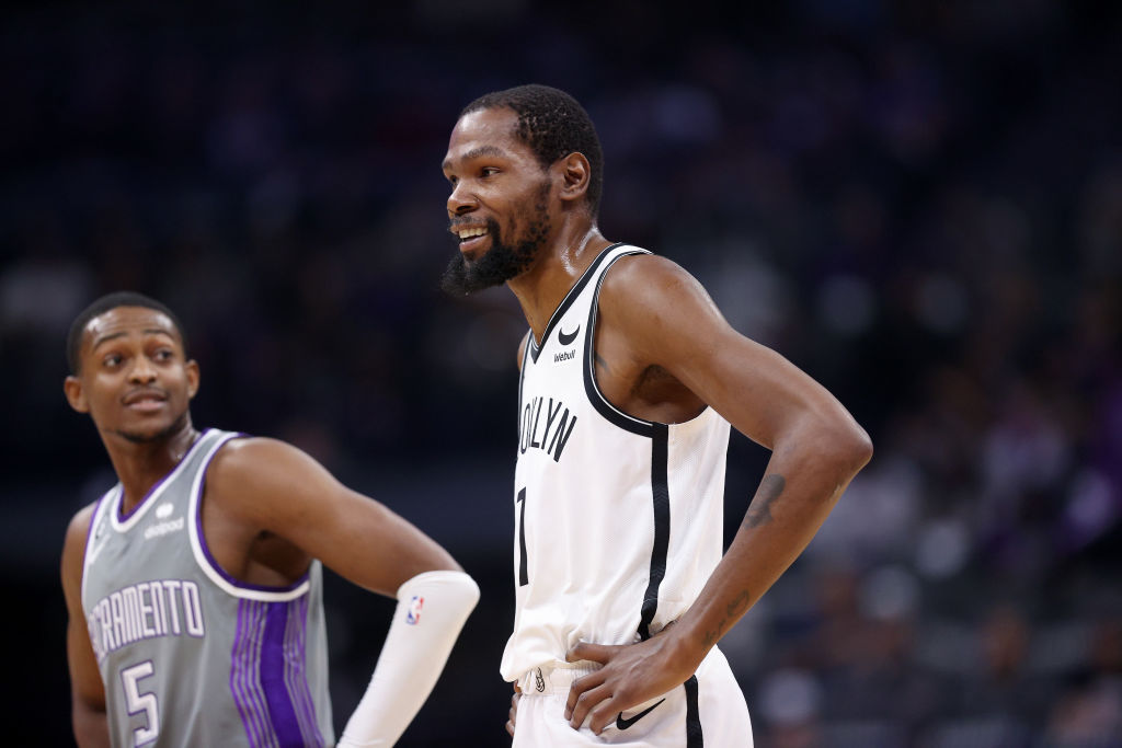 Sacramento Kings guard De'Aaron Fox stands next to Kevin Durant of the Brooklyn Nets at Golden 1 Ce...