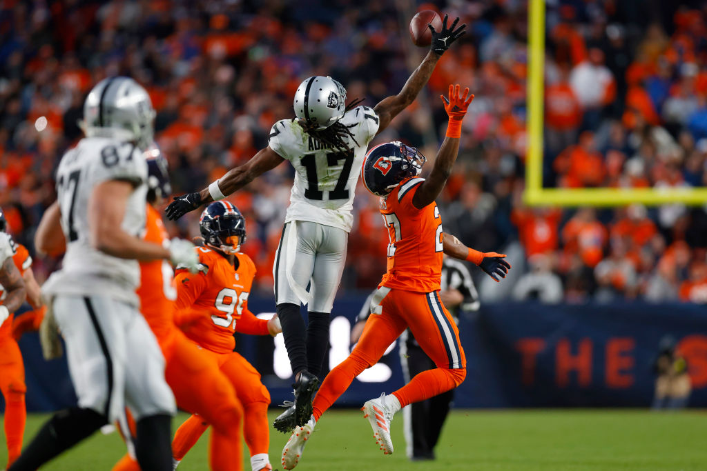 Davante Adams #17 of the Las Vegas Raiders defends a tipped pass to prevent an interception by Dama...