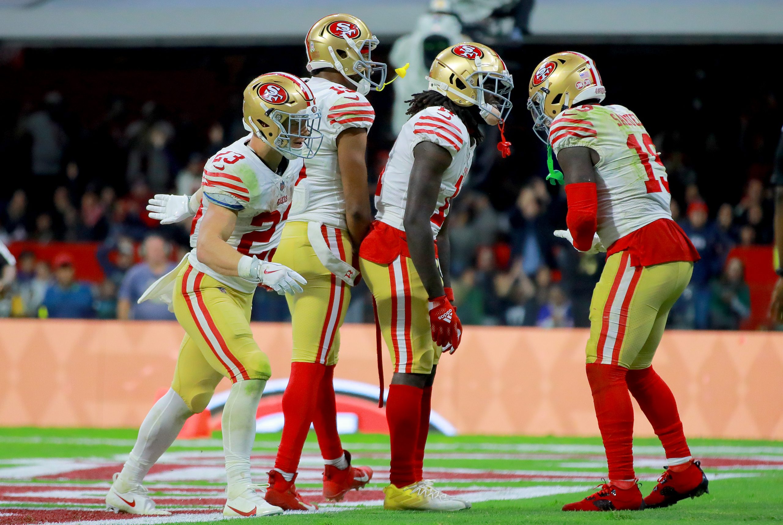 Brandon Aiyuk #11 of the San Francisco 49ers celebrates with teammates after scoring a touchdown ag...