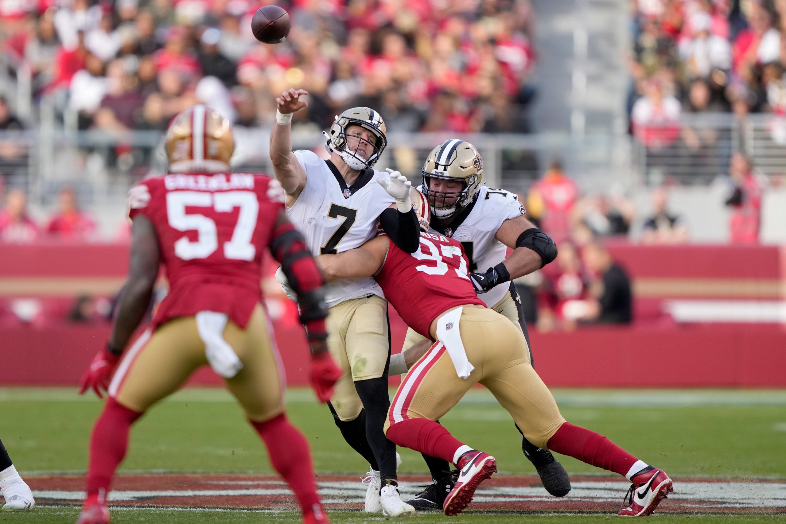 Taysom Hill #7 of the New Orleans Saints is hit by Nick Bosa #97 of the San Francisco 49ers during ...
