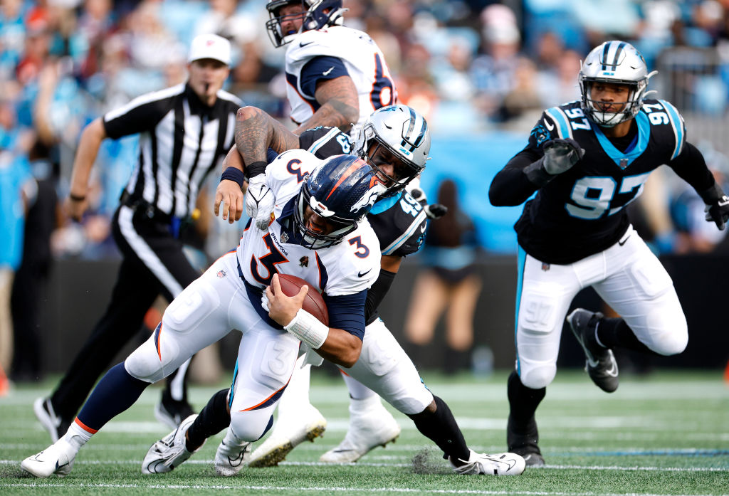 Frankie Luvu #49 of the Carolina Panthers sacks Russell Wilson #3 of the Denver Broncos during the ...