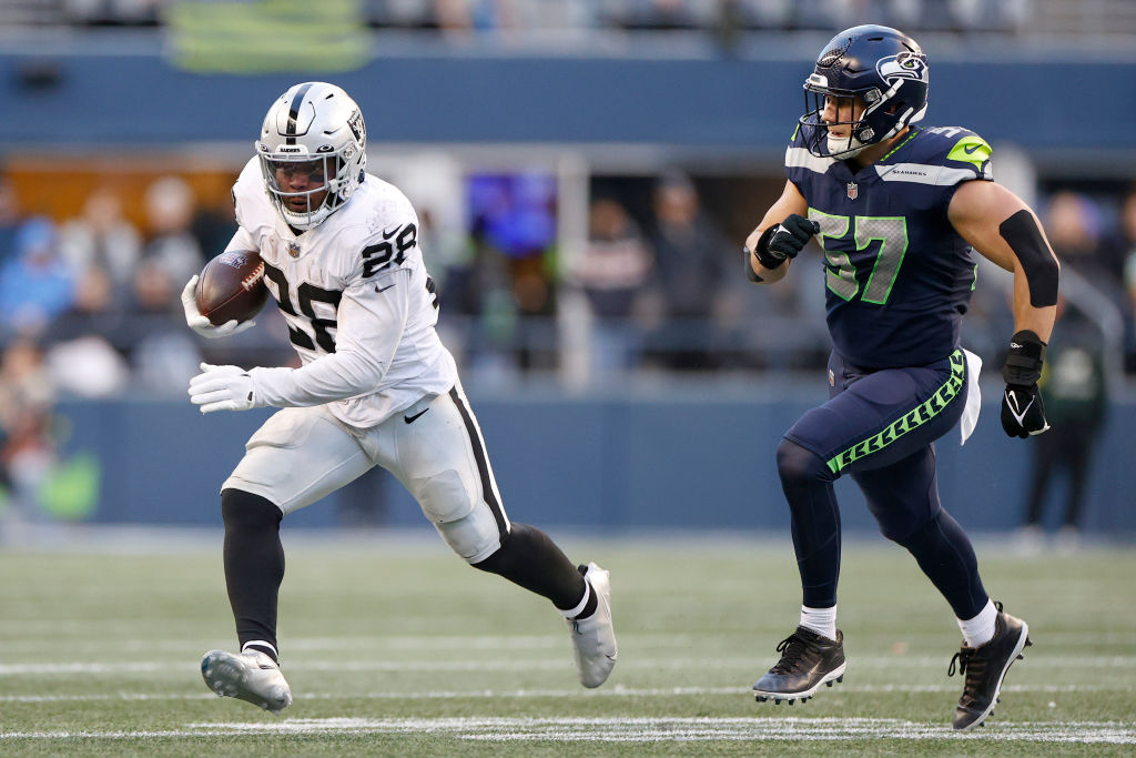Josh Jacobs #28 of the Las Vegas Raiders carries the ball against the Seattle Seahawks during the f...