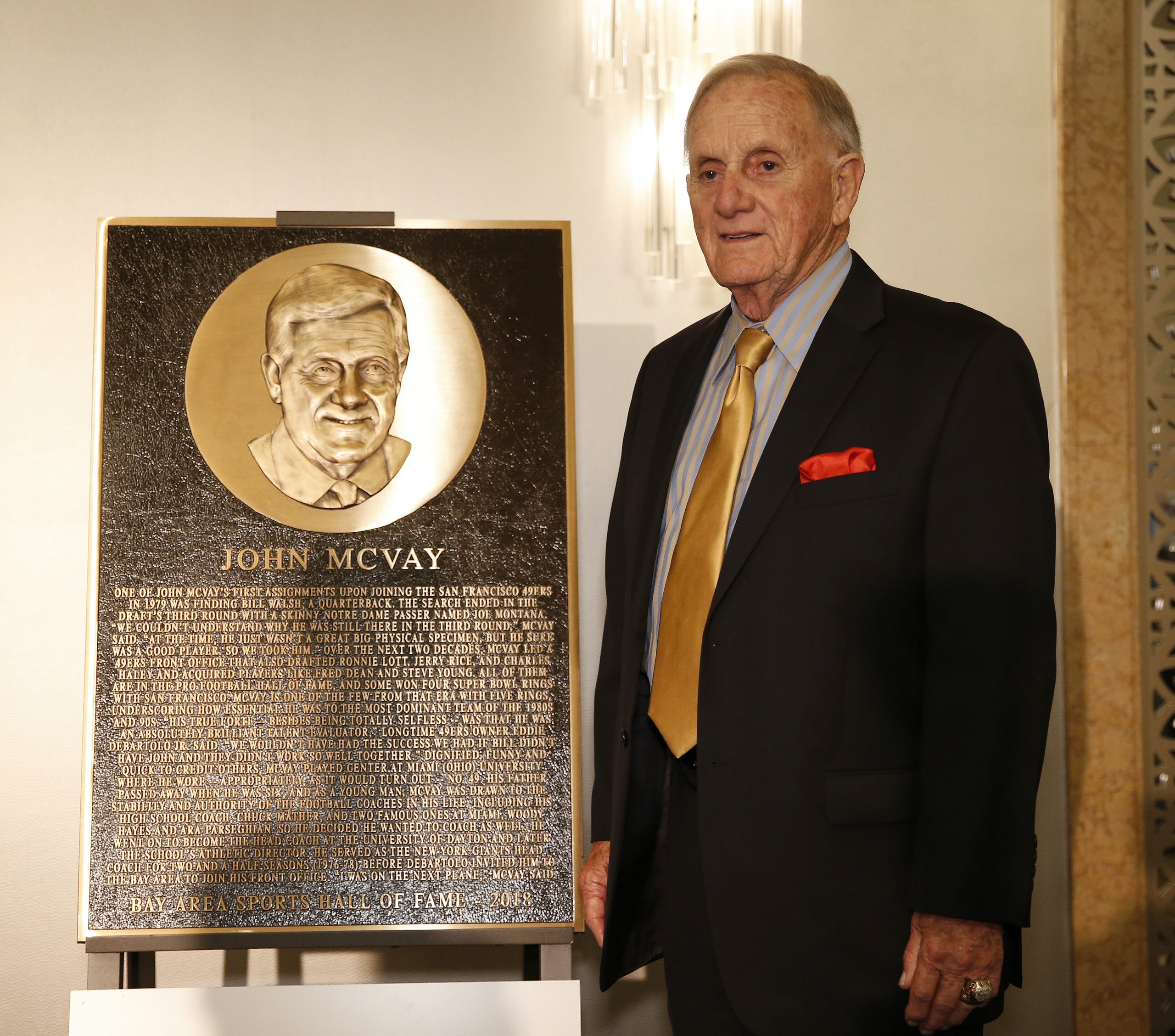 Former San Francisco 49ers executive John McVay poses next to his honorary plaque during the San Fr...