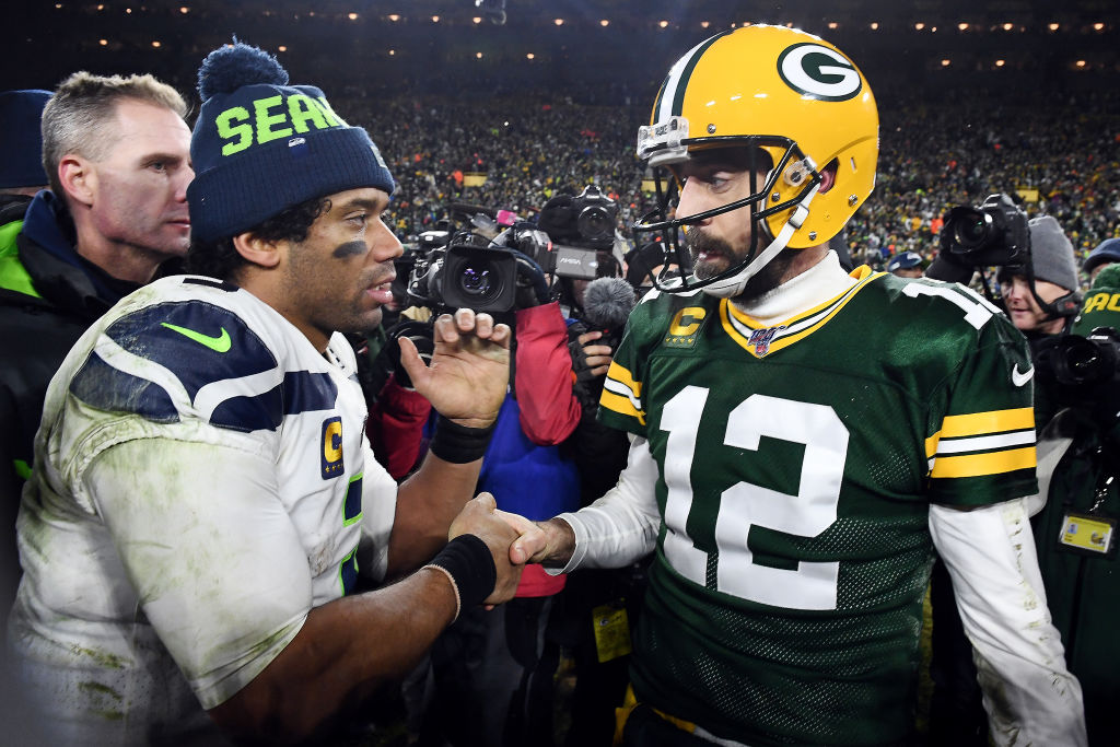 Russell Wilson #3 of the Seattle Seahawks greets Aaron Rodgers #12 of the Green Bay Packers after t...