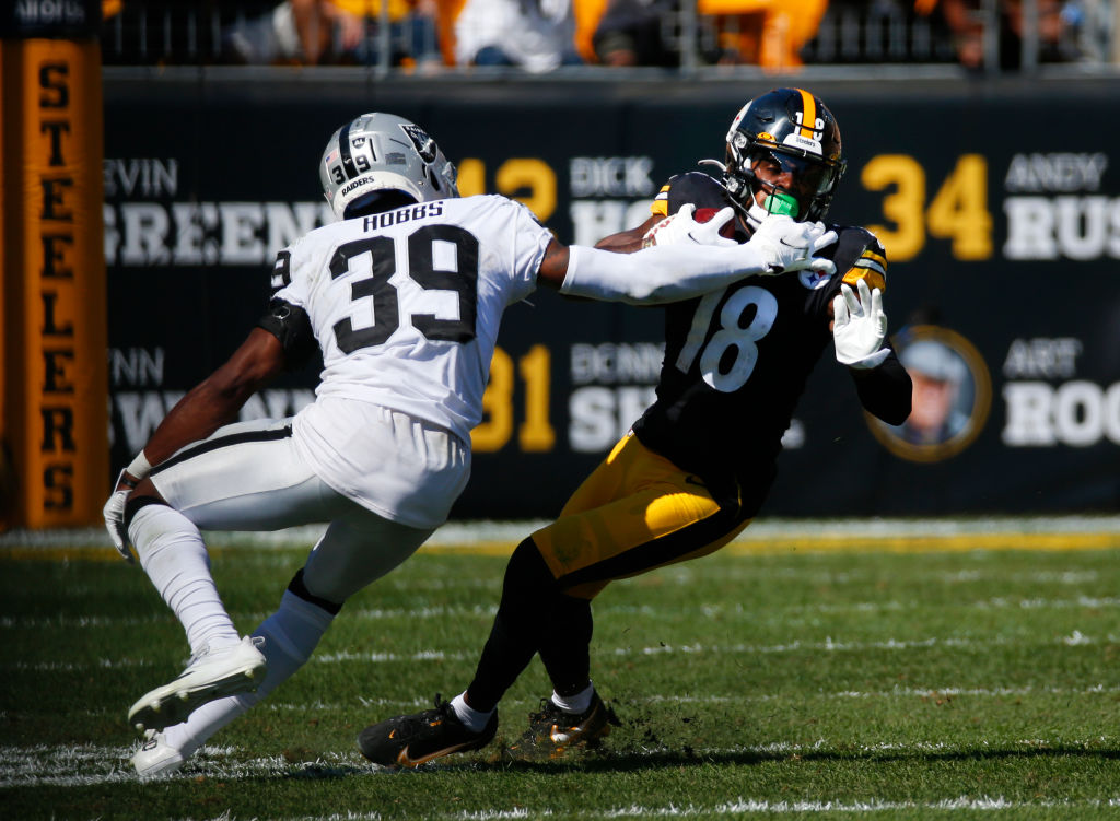 Wide receiver Diontae Johnson #18 of the Pittsburgh Steelers runs with the ball against cornerback ...