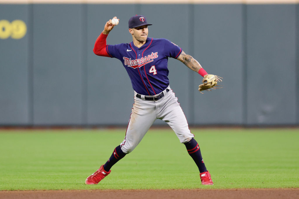 Carlos Correa #4 of the Minnesota Twins throws out Yuli Gurriel #10 of the Houston Astros during th...