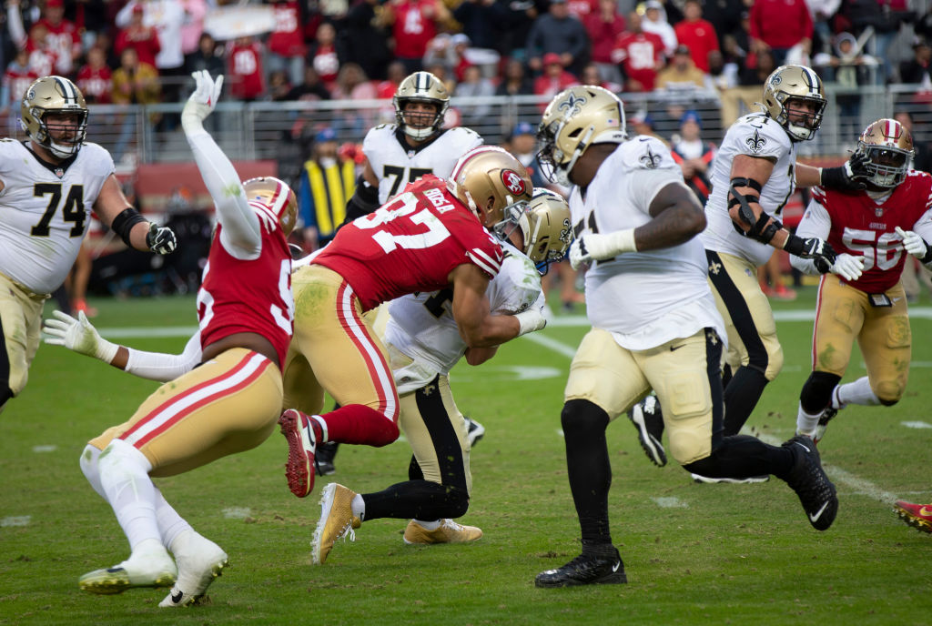Nick Bosa #97 of the San Francisco 49ers sacks Andy Dalton #14 of the New Orleans Saints during the...