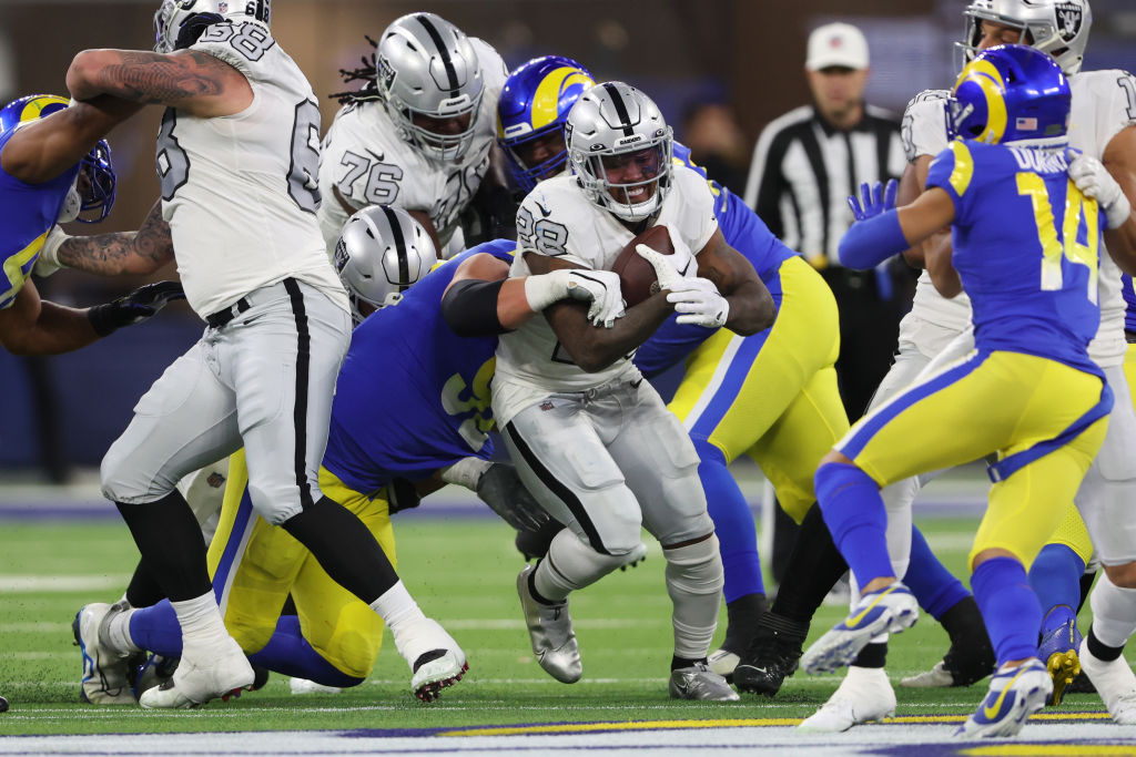 Josh Jacobs #28 of the Las Vegas Raiders carries the ball against the Los Angeles Rams during the s...