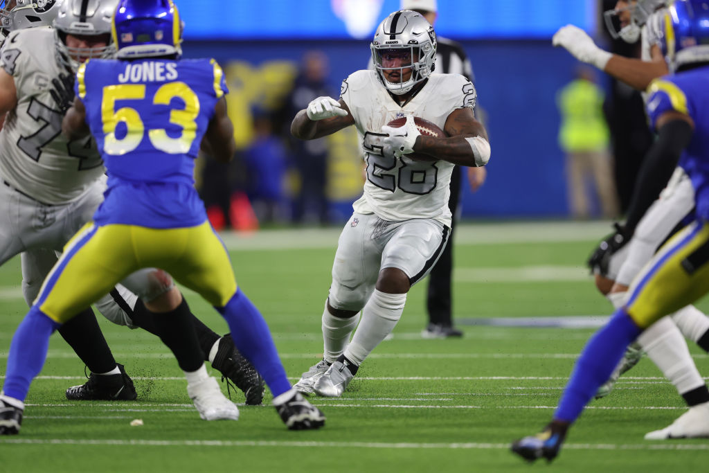 Josh Jacobs #28 of the Las Vegas Raiders carries the ball against the Los Angeles Rams during the f...