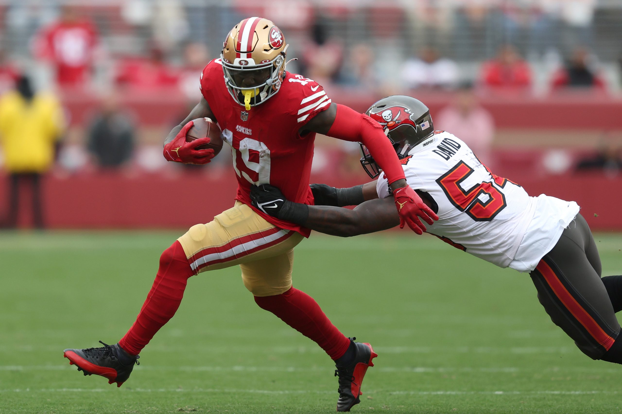 Deebo Samuel #19 of the San Francisco 49ers runs the ball while being tackled by Lavonte David #54 ...