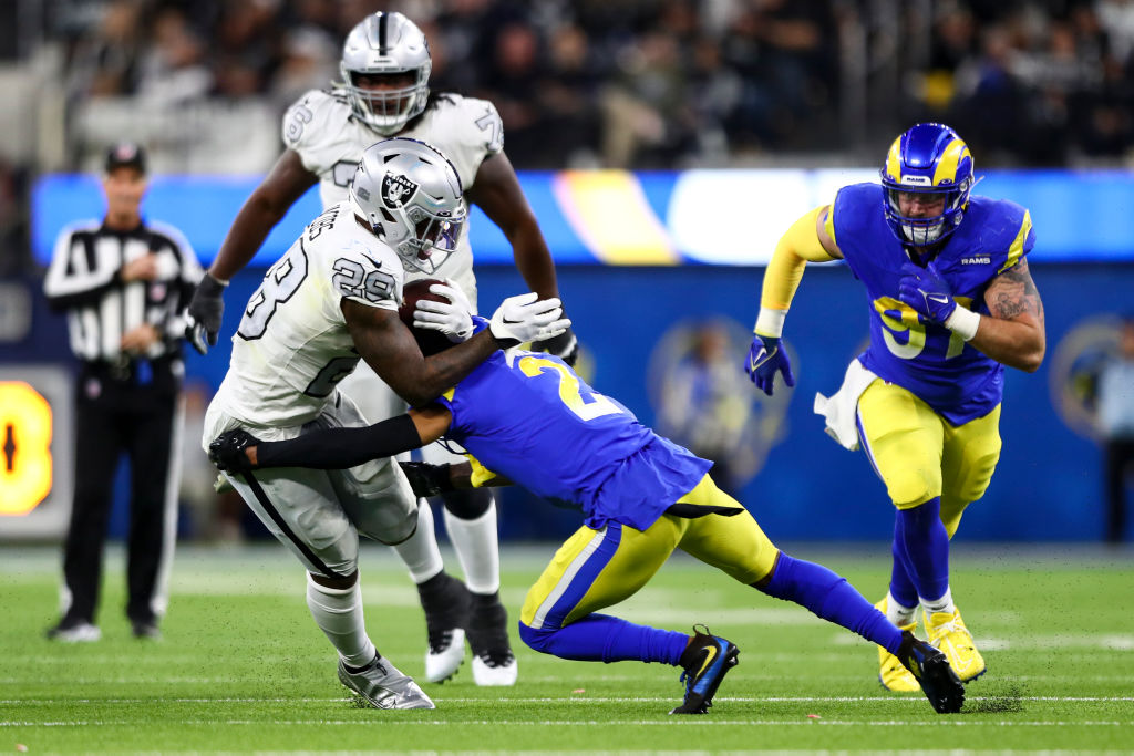 Troy Hill #2 of the Los Angeles Rams tackles Josh Jacobs #28 of the Las Vegas Raiders during an NFL...