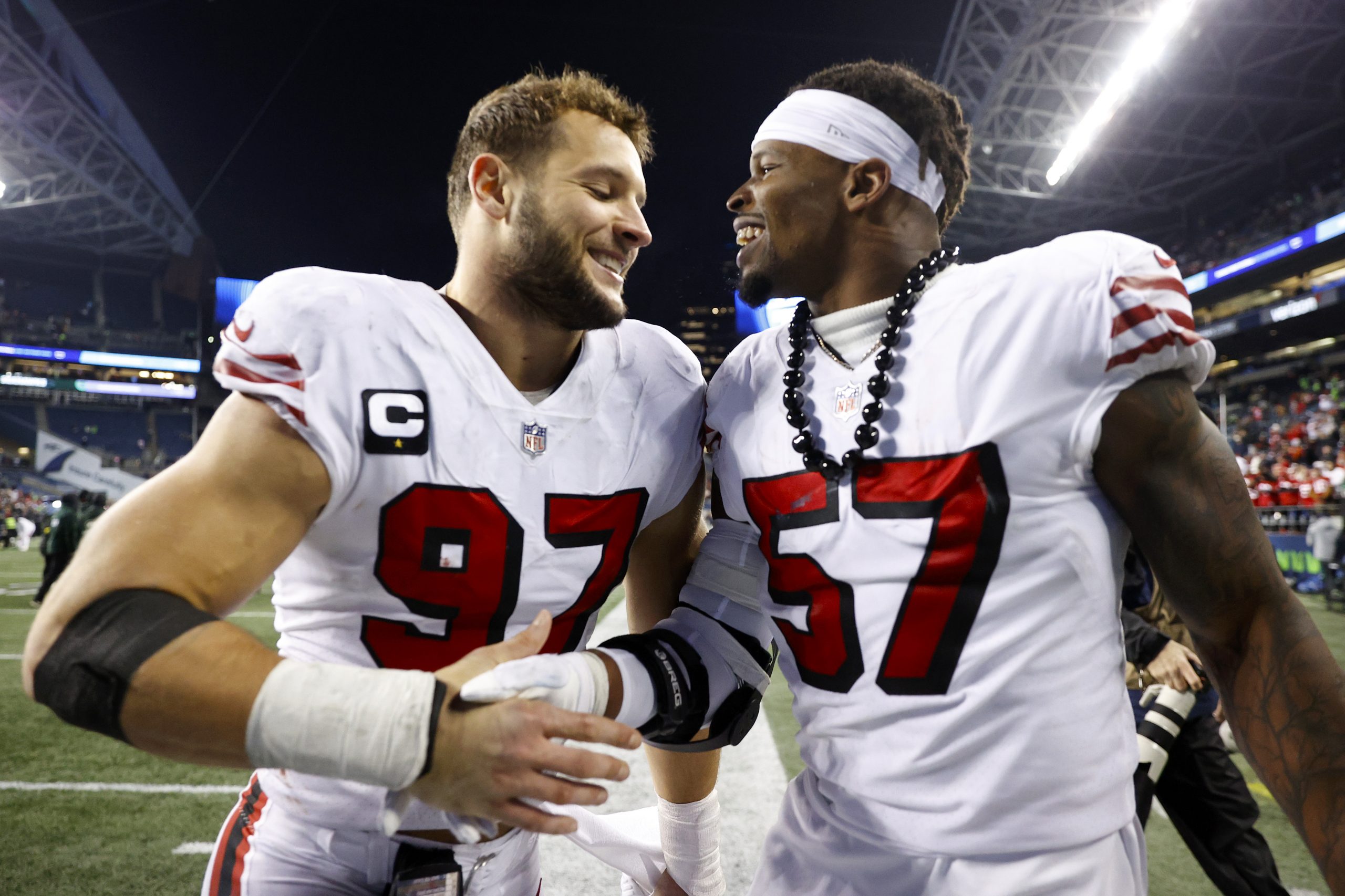 Nick Bosa #97 and Dre Greenlaw #57 of the San Francisco 49ers celebrate after defeating the Seattle...