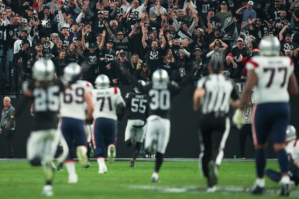 Fans cheer as Chandler Jones #55 of the Las Vegas Raiders scores a touchdown to defeat the New Engl...