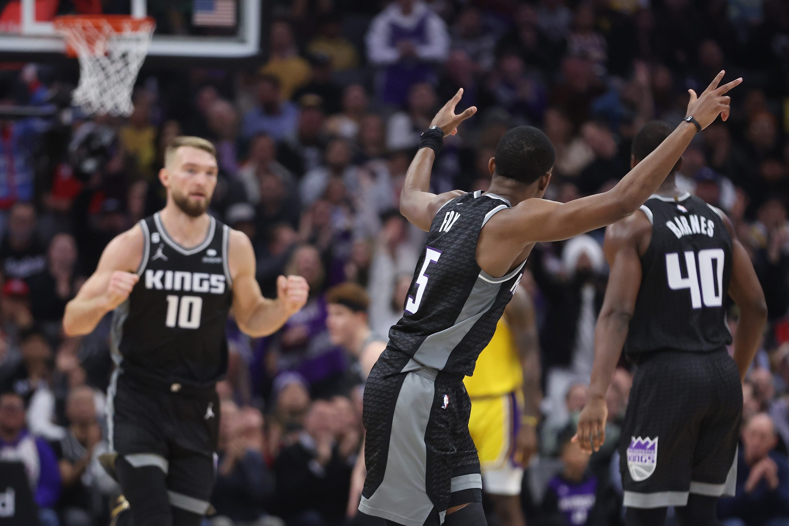 De'Aaron Fox and Domantas Sabonis of the Sacramento Kings react after a three-point basket in the s...