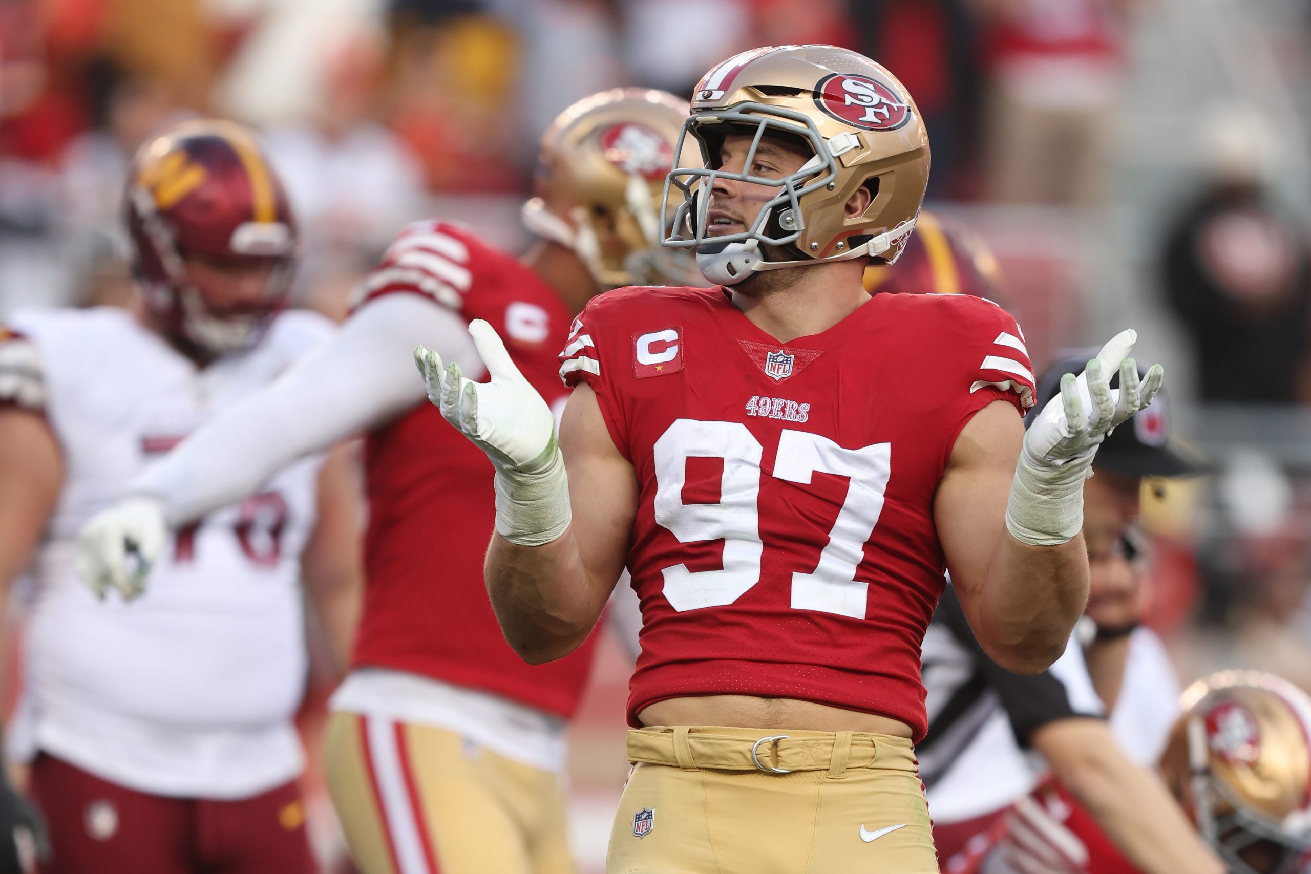 Nick Bosa #97 of the San Francisco 49ers reacts after forcing a fumble during the fourth quarter in...
