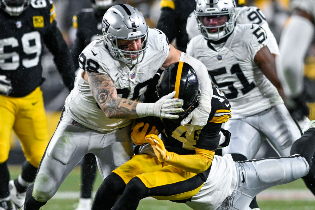 George Pickens #14 of the Pittsburgh Steelers is tackled by Maxx Crosby #98 of the Las Vegas Raider...