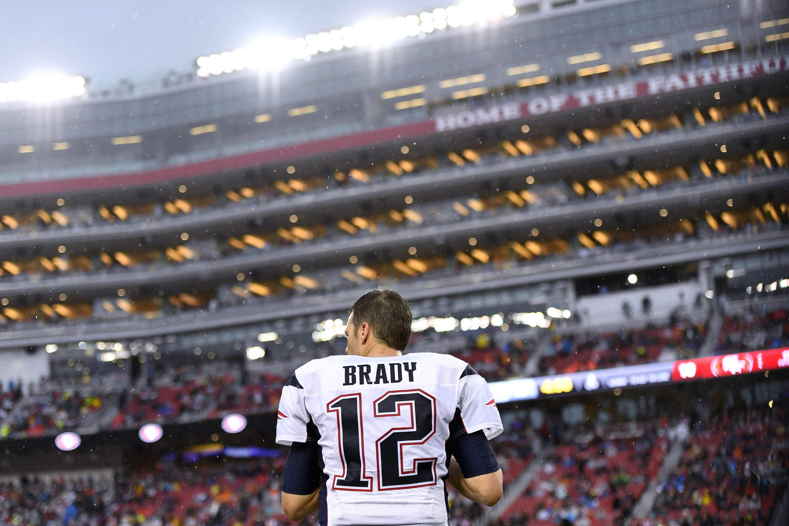 New England Patriots quarterback Tom Brady (12) warms up by throwing the football during the regula...