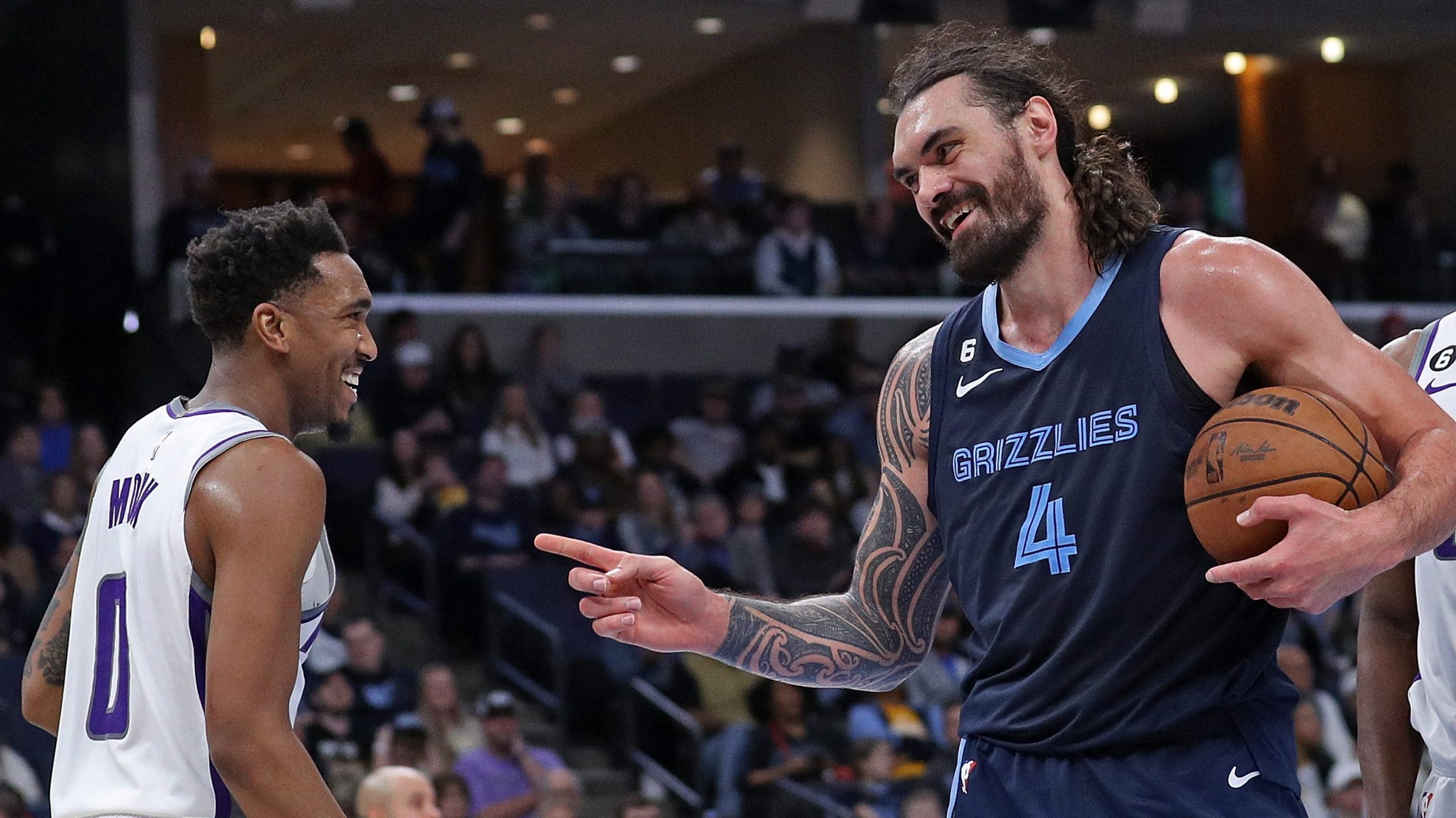 Steven Adams #4 of the Memphis Grizzlies and Malik Monk #0 of the Sacramento Kings react during the...