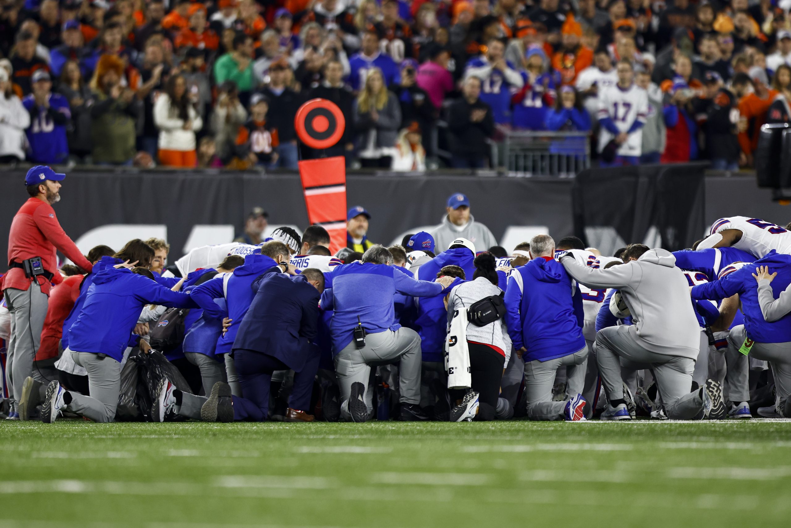 CINCINNATI, OH - JANUARY 2: Buffalo Bills players and staff kneel together in solidarity after Dama...