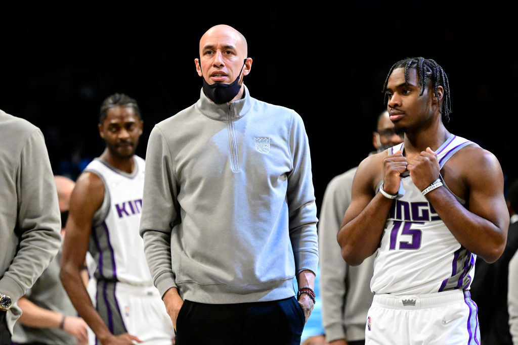 Assistant coach Doug Christie and guard Davion Mitchell of the Sacramento Kings looks on during the...