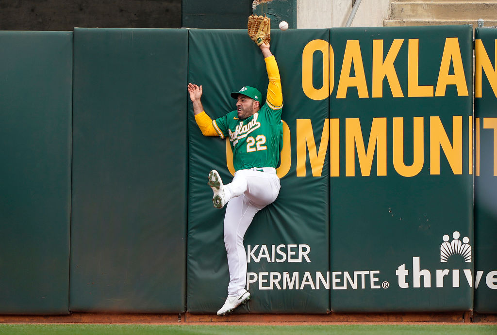 Ramon Laureano #22 of the Oakland Athletics leaping at the wall just misses the this ball that goes...