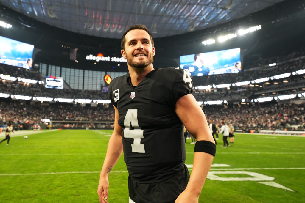 Derek Carr #4 of the Las Vegas Raiders celebrates on the field after defeating the New England Patr...