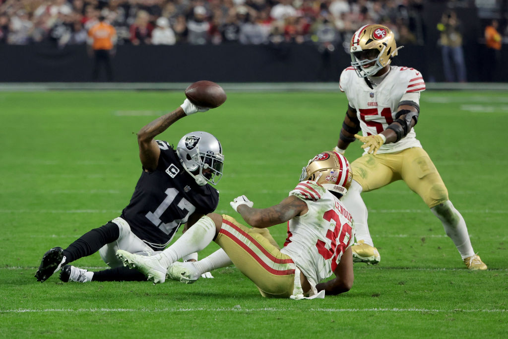 Wide receiver Davante Adams #17 of the Las Vegas Raiders holds up the ball after making a 45-yard c...