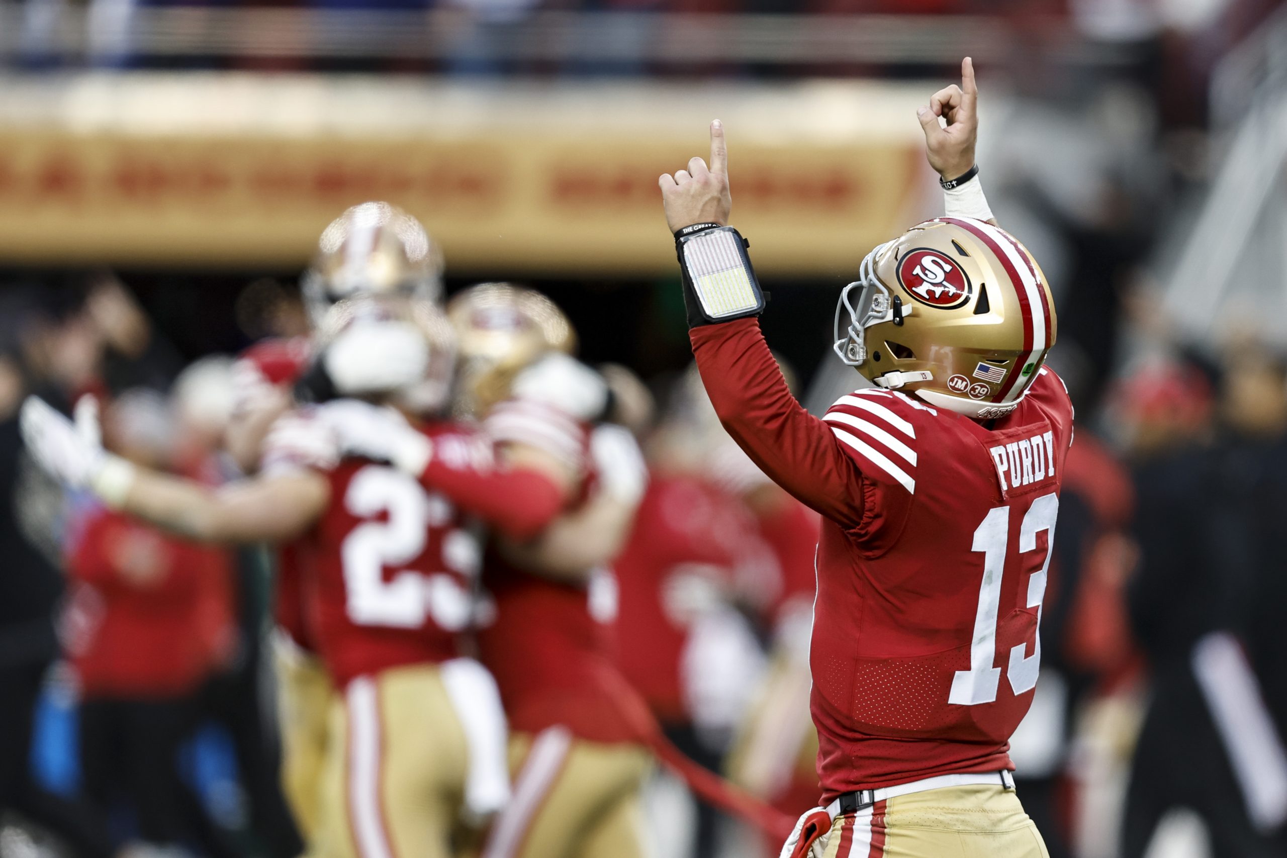 Brock Purdy #13 of the San Francisco 49ers celebrates after a touchdown during an NFL football game...