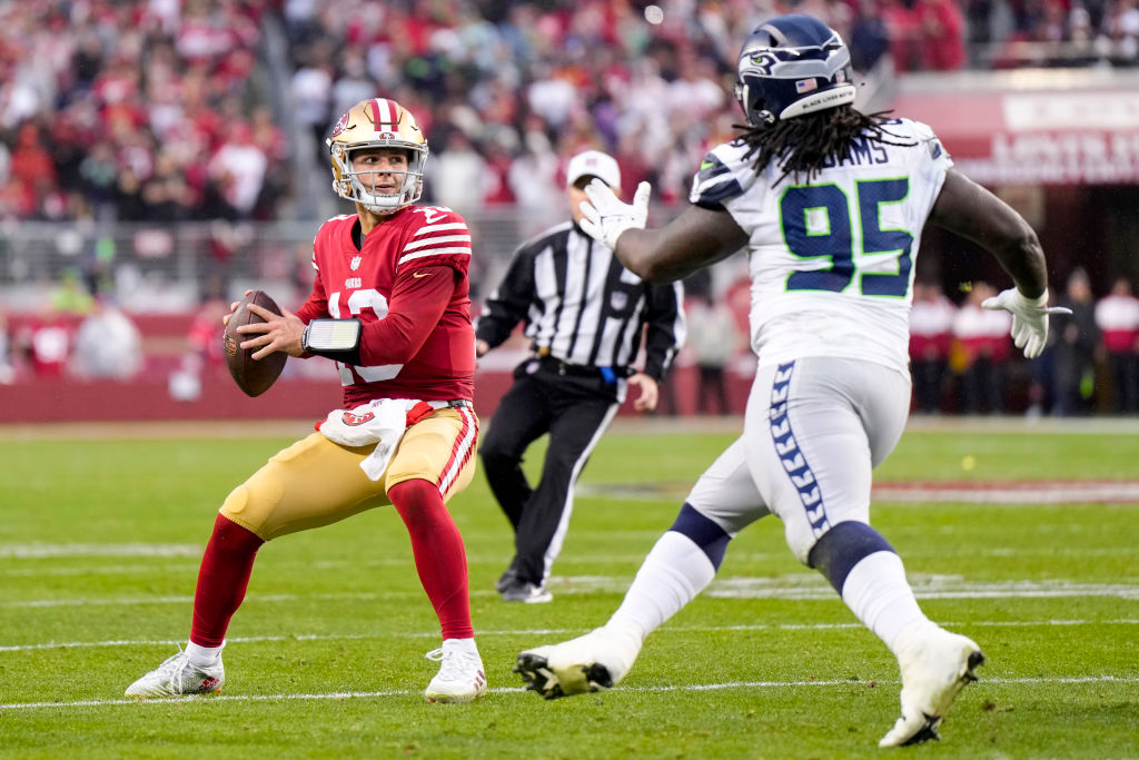 Brock Purdy #13 of the San Francisco 49ers looks to pass against the Seattle Seahawks during the se...
