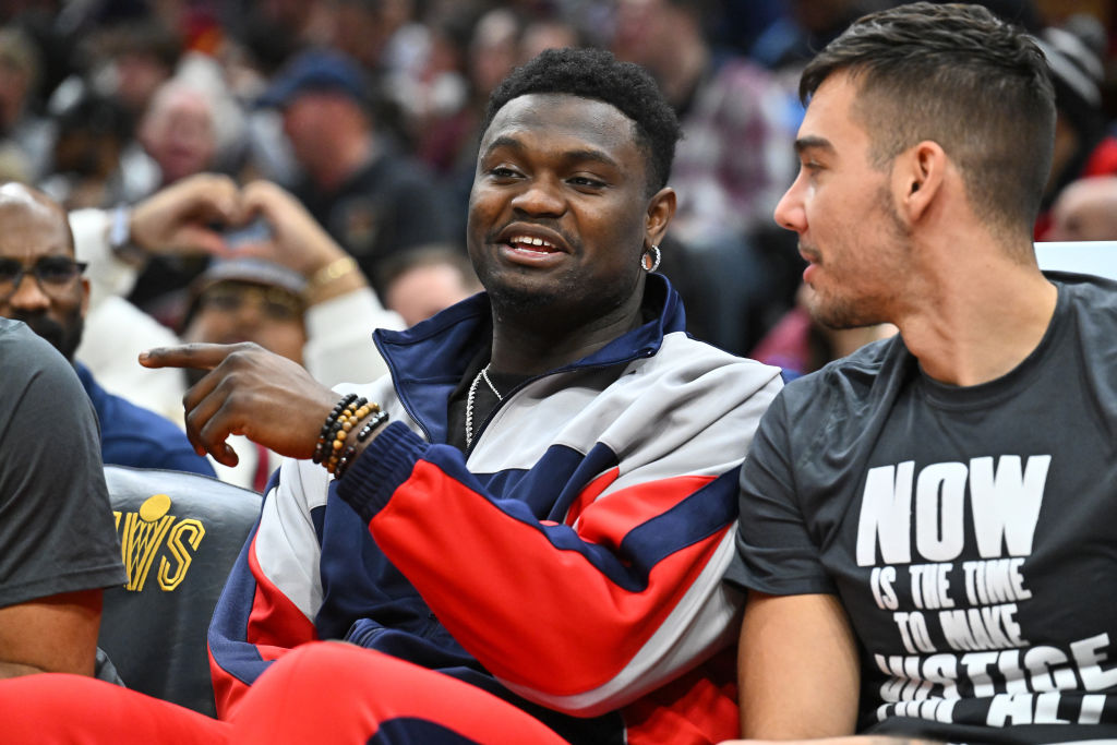 Zion Williamson #1 talks with Willy Hernangomez #9 of the New Orleans Pelicans while on the bench d...