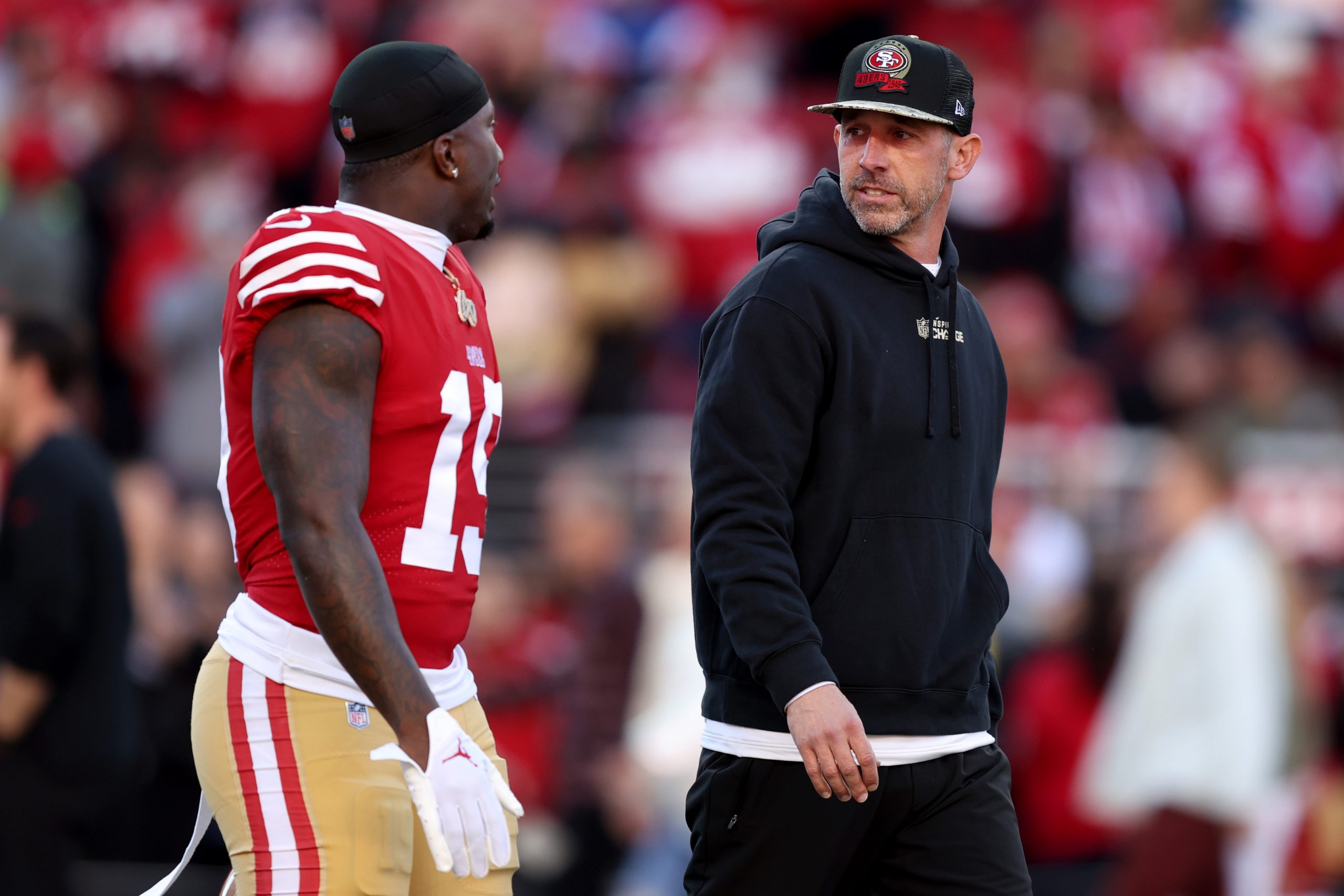 Deebo Samuel #19 and head coach Kyle Shanahan of the San Francisco 49ers talk on the field prior to...