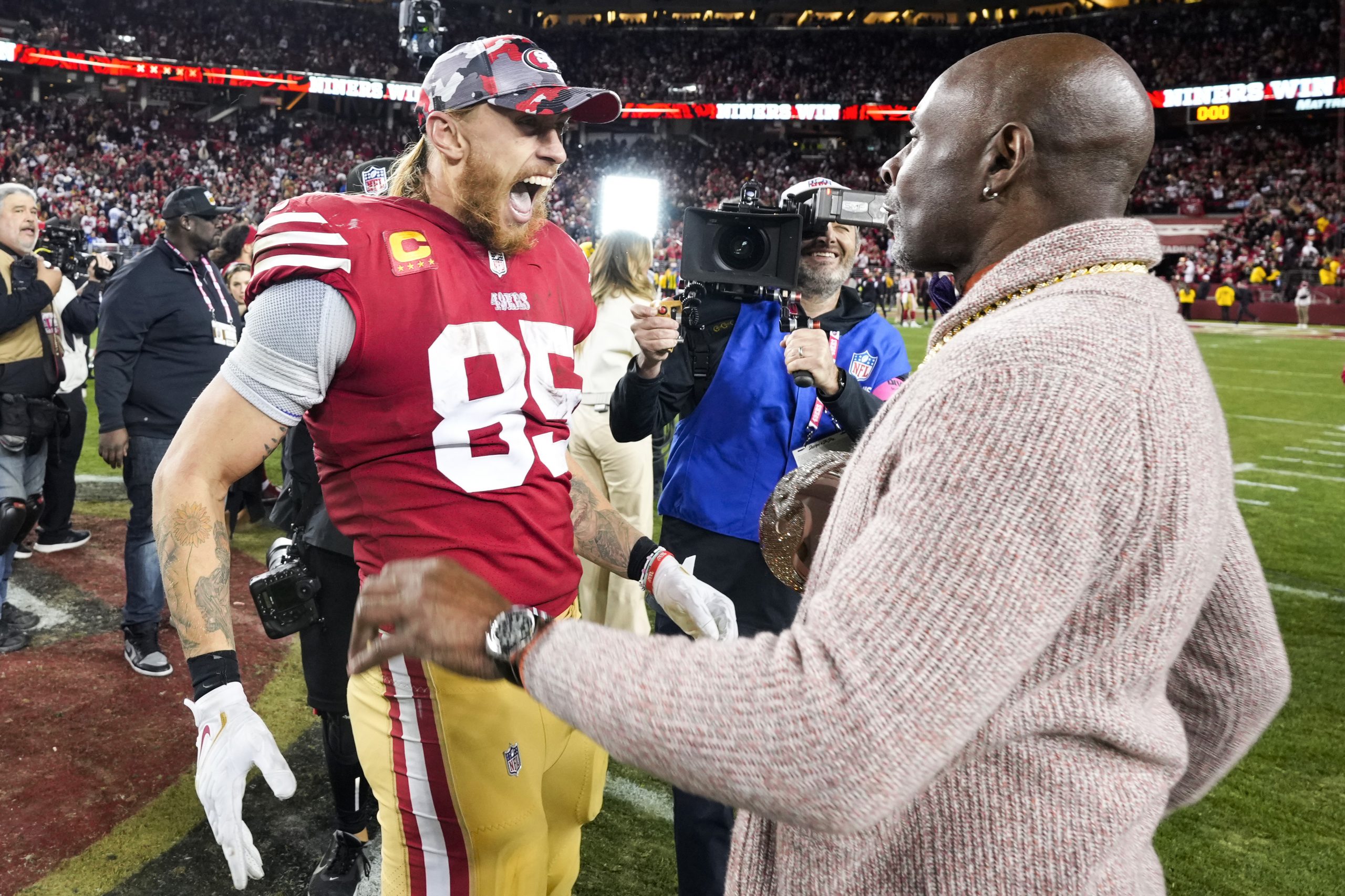 George Kittle #85 of the San Francisco 49ers celebrates with NFL Hall of Famer Jerry Rice after def...